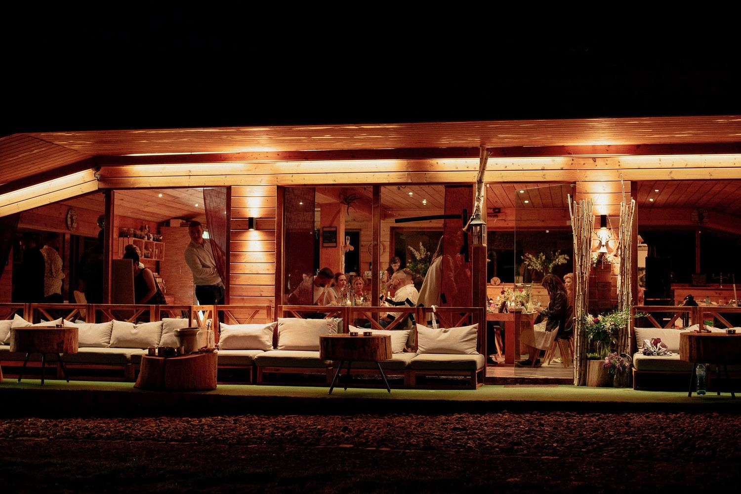 Long exposure night shot of a rustic wooden building with warm lighting.
