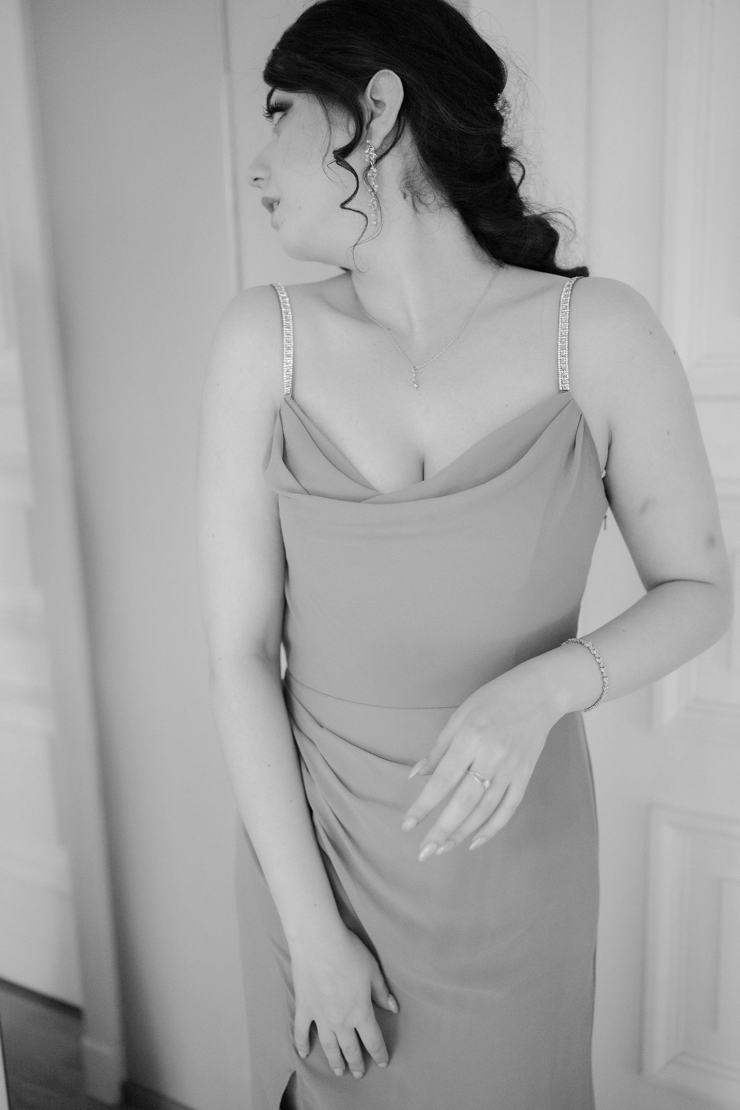 Black and white portrait series showing elegant poses in a sleeveless dress against a light background.
