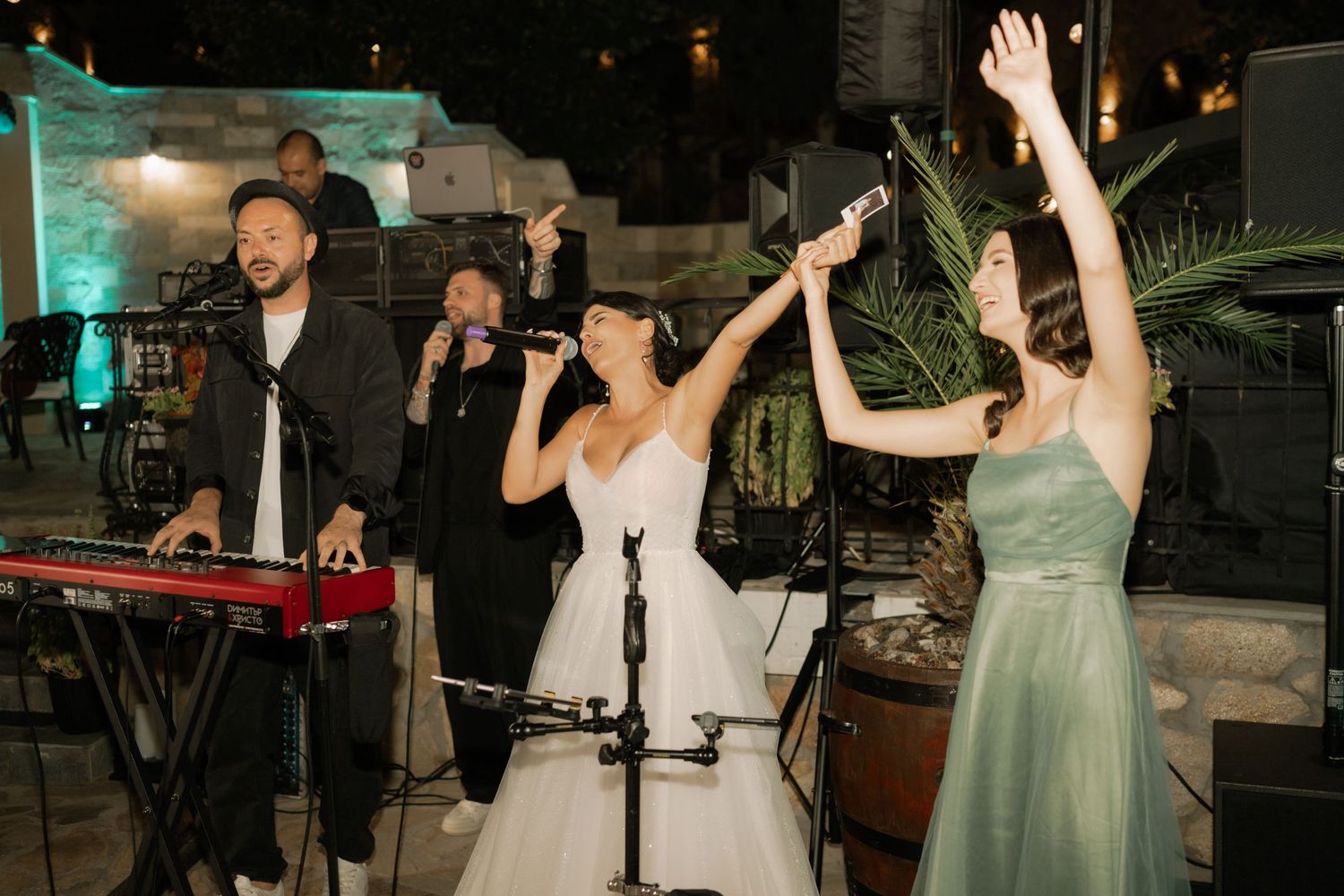 Wedding reception guests dancing and celebrating together on the dance floor at an evening party.