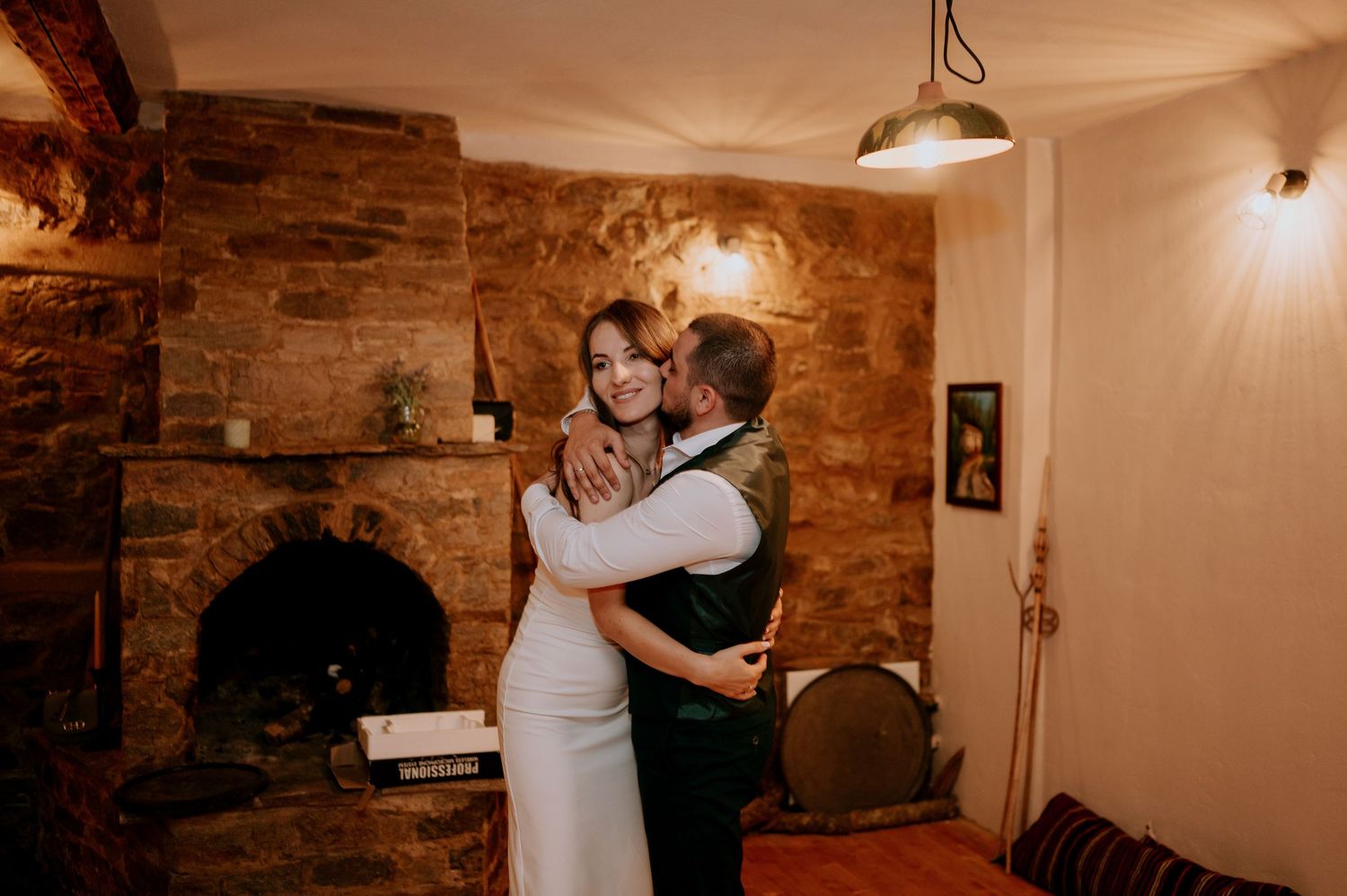 Romantic dance scene in a rustic venue with exposed brick and ambient lighting.