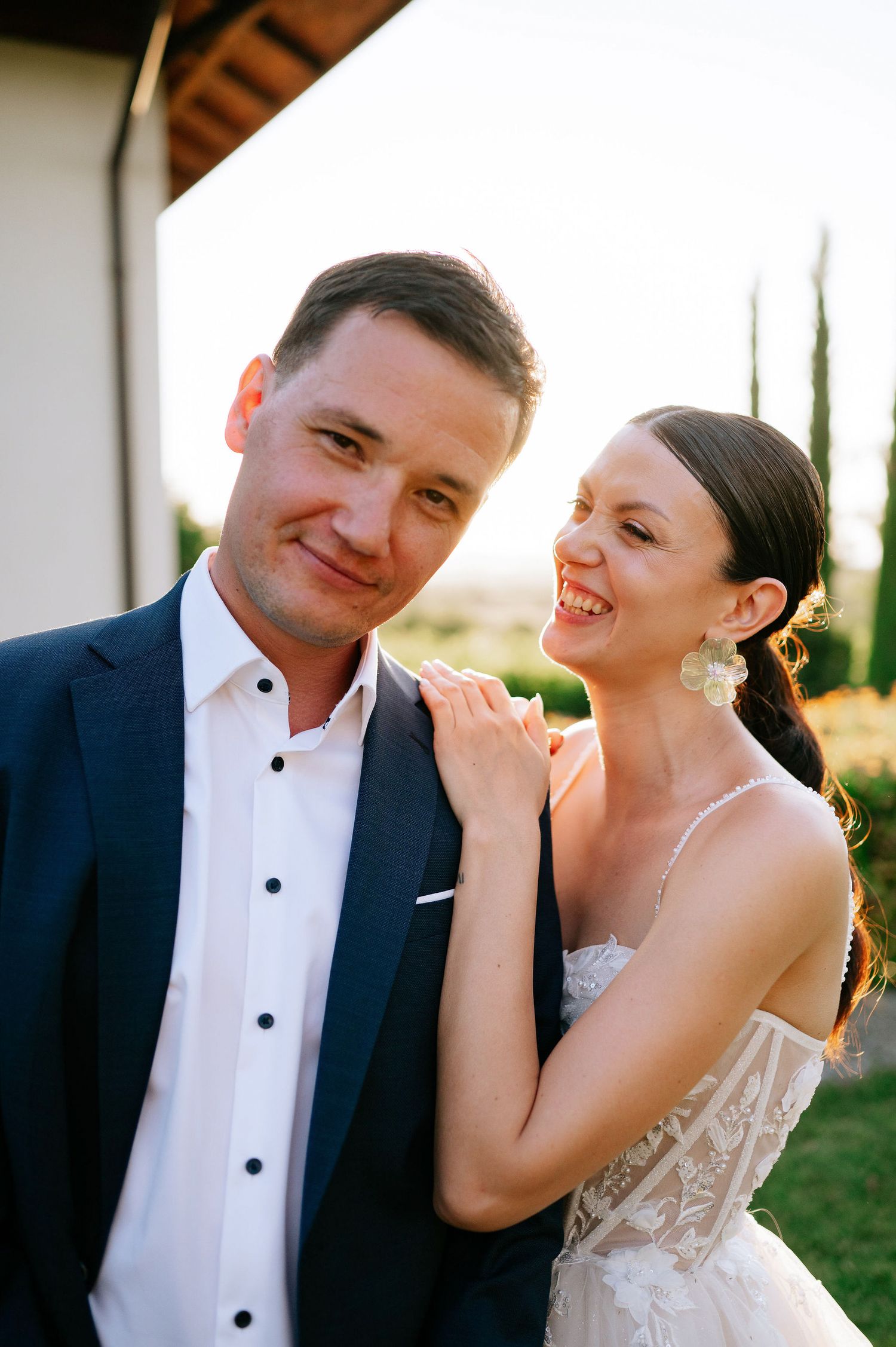 Romantic close-up wedding portraits of a couple sharing joyful moments in golden sunlight.