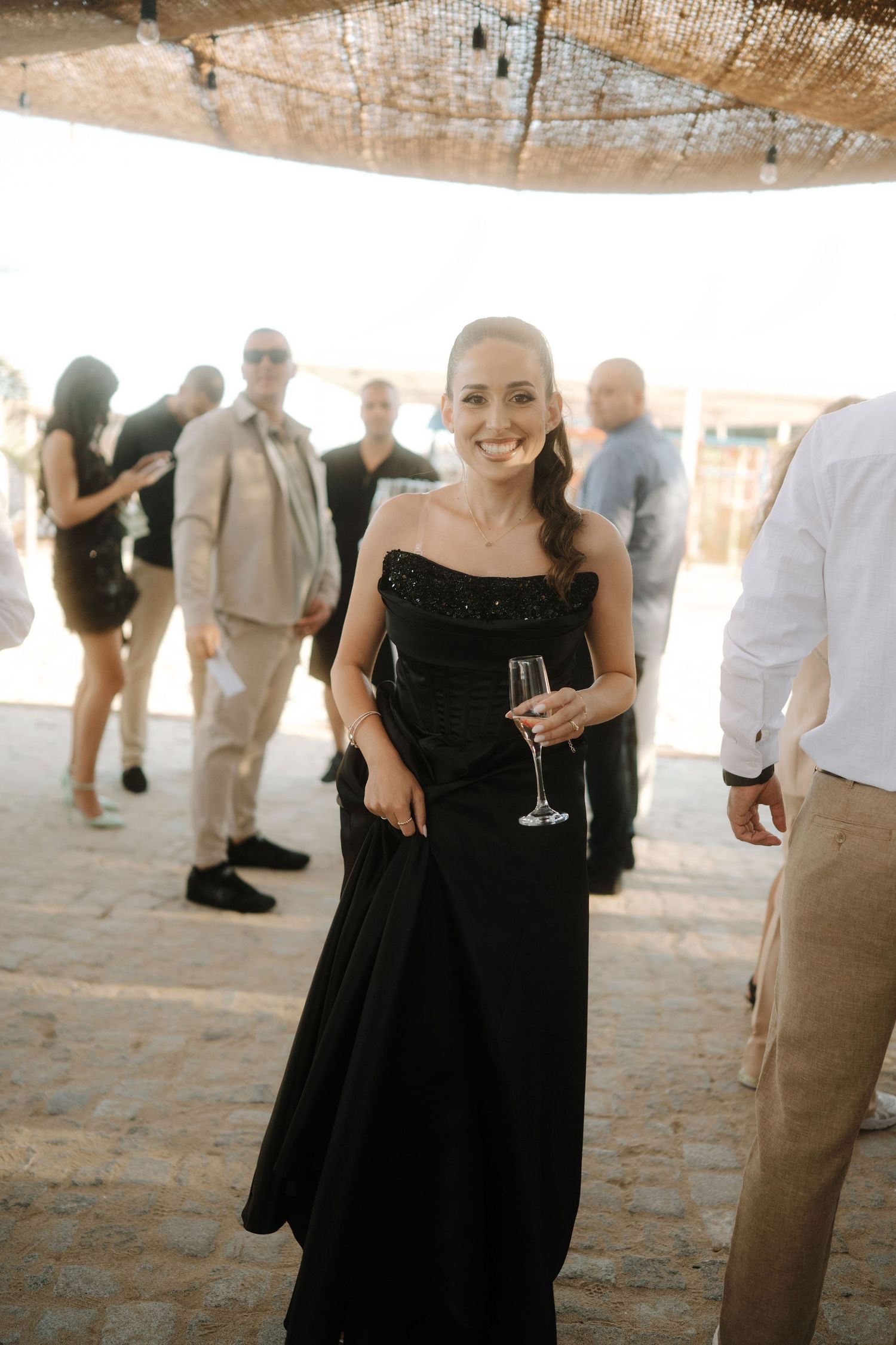 Wedding guests in formal attire mingle and socialize during an elegant reception celebration.