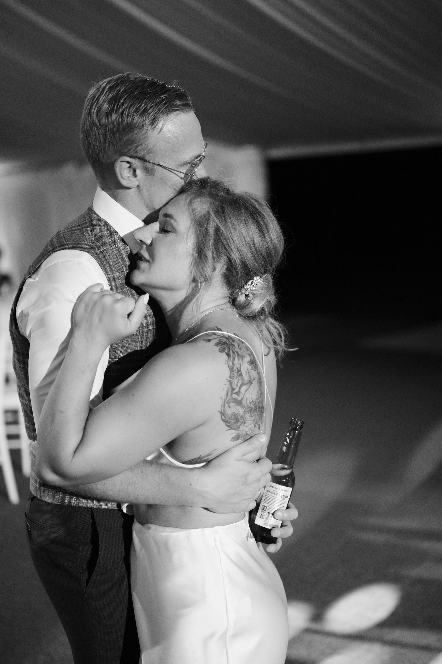 A romantic black and white sequence of a couple sharing their first dance at a wedding reception.