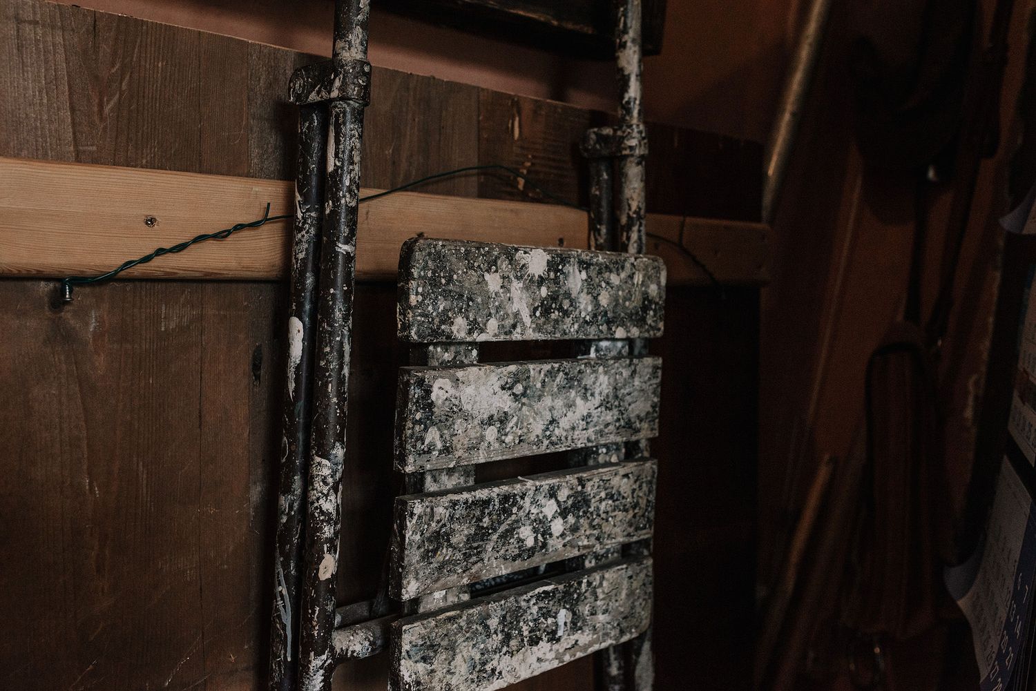 Industrial-style metal fixtures and pipes against a distressed wall.