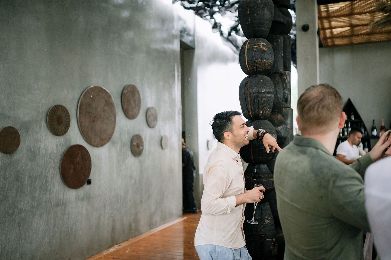 Guests mingling at a party with circular wall decorations.