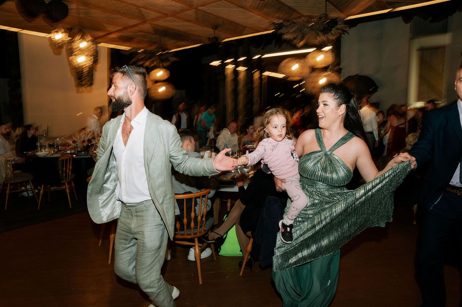 Wedding reception dance floor filled with guests enjoying lively celebration.