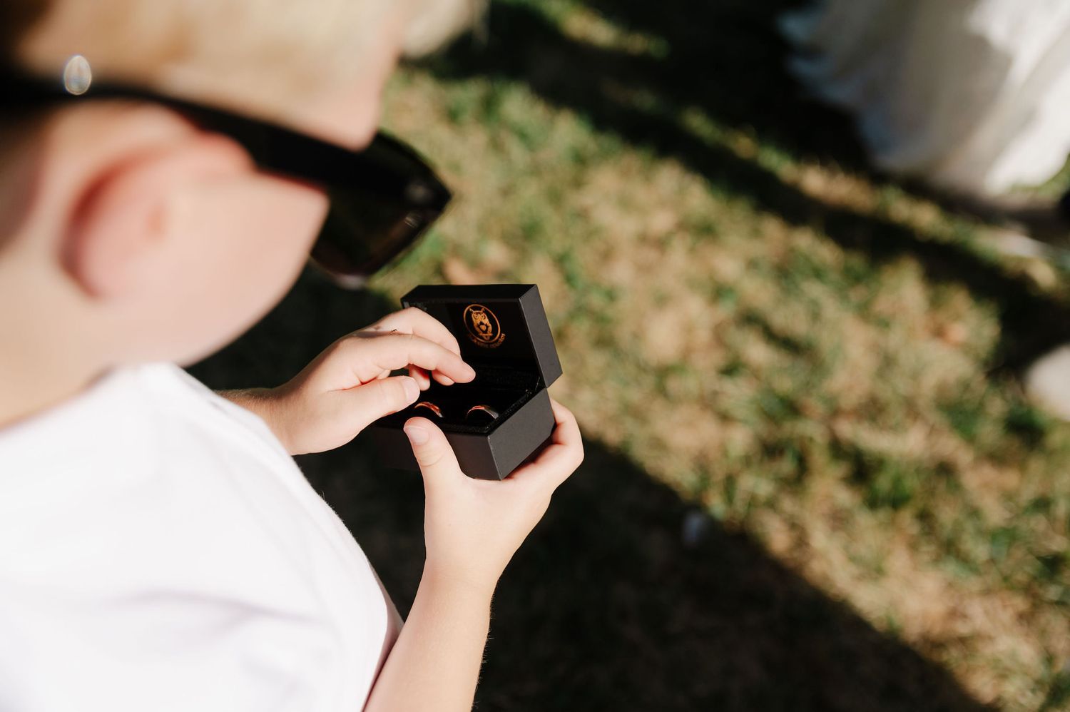 Close-up shot of hands holding a camera during outdoor event.