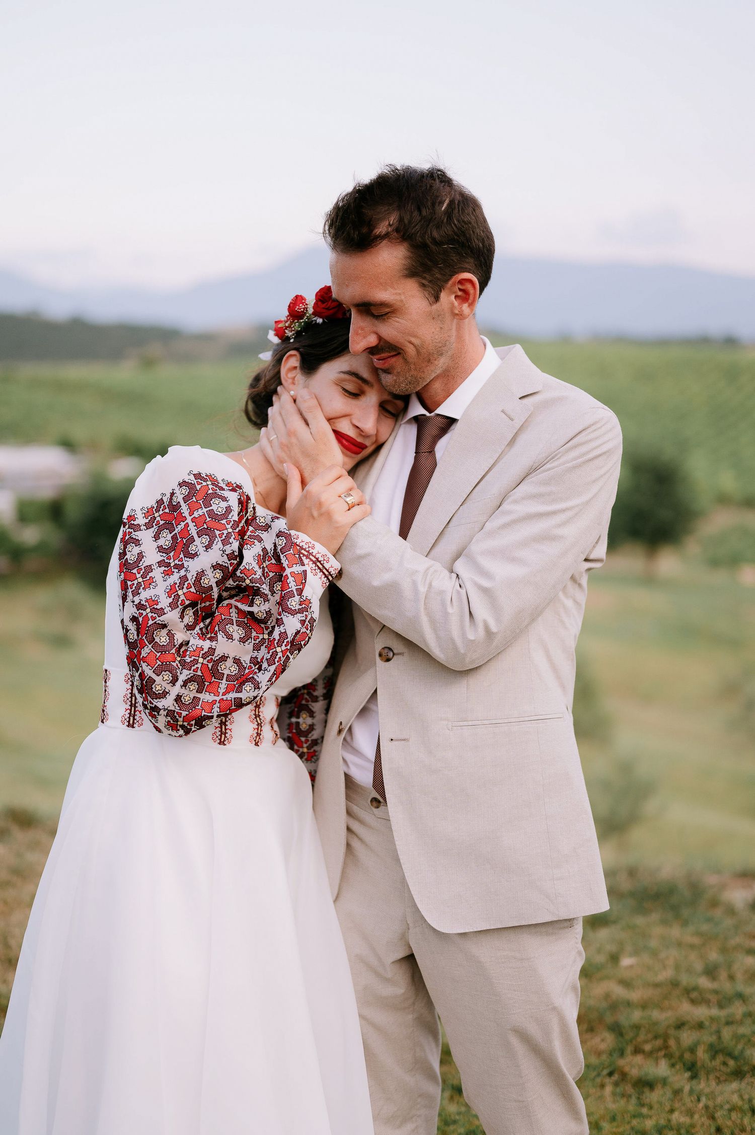 Sweet candid moment between newlyweds in a scenic mountain setting.