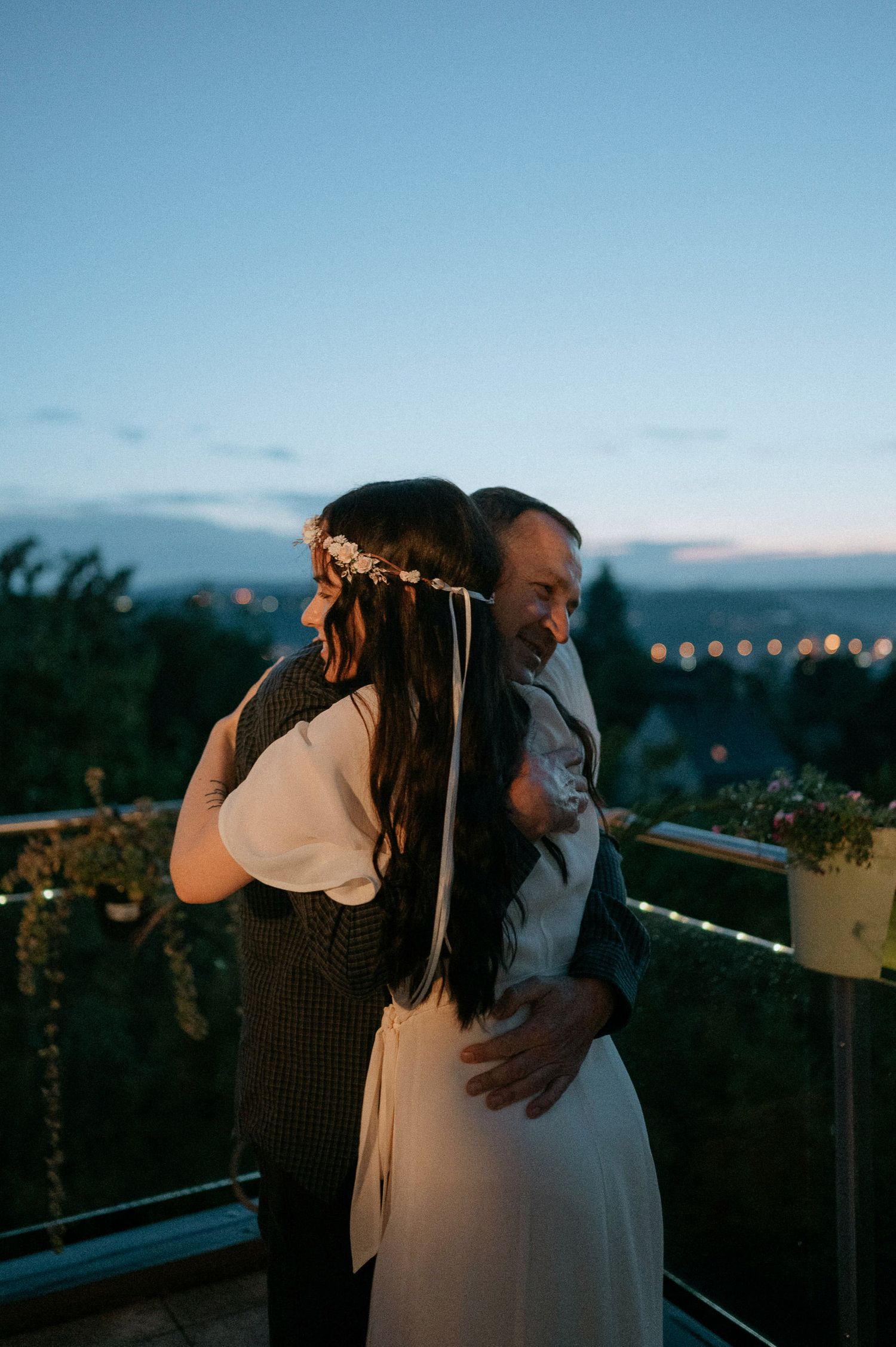 Romantic evening dance on outdoor terrace with sunset backdrop.