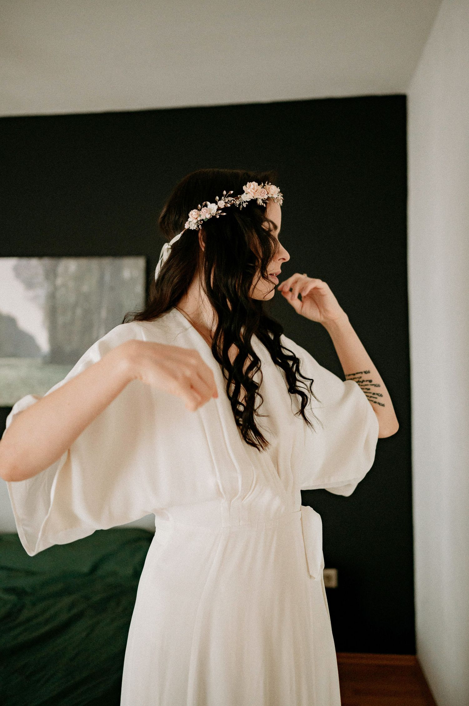 Intimate portrait series showing movement in a flowing white dress against minimalist decor.