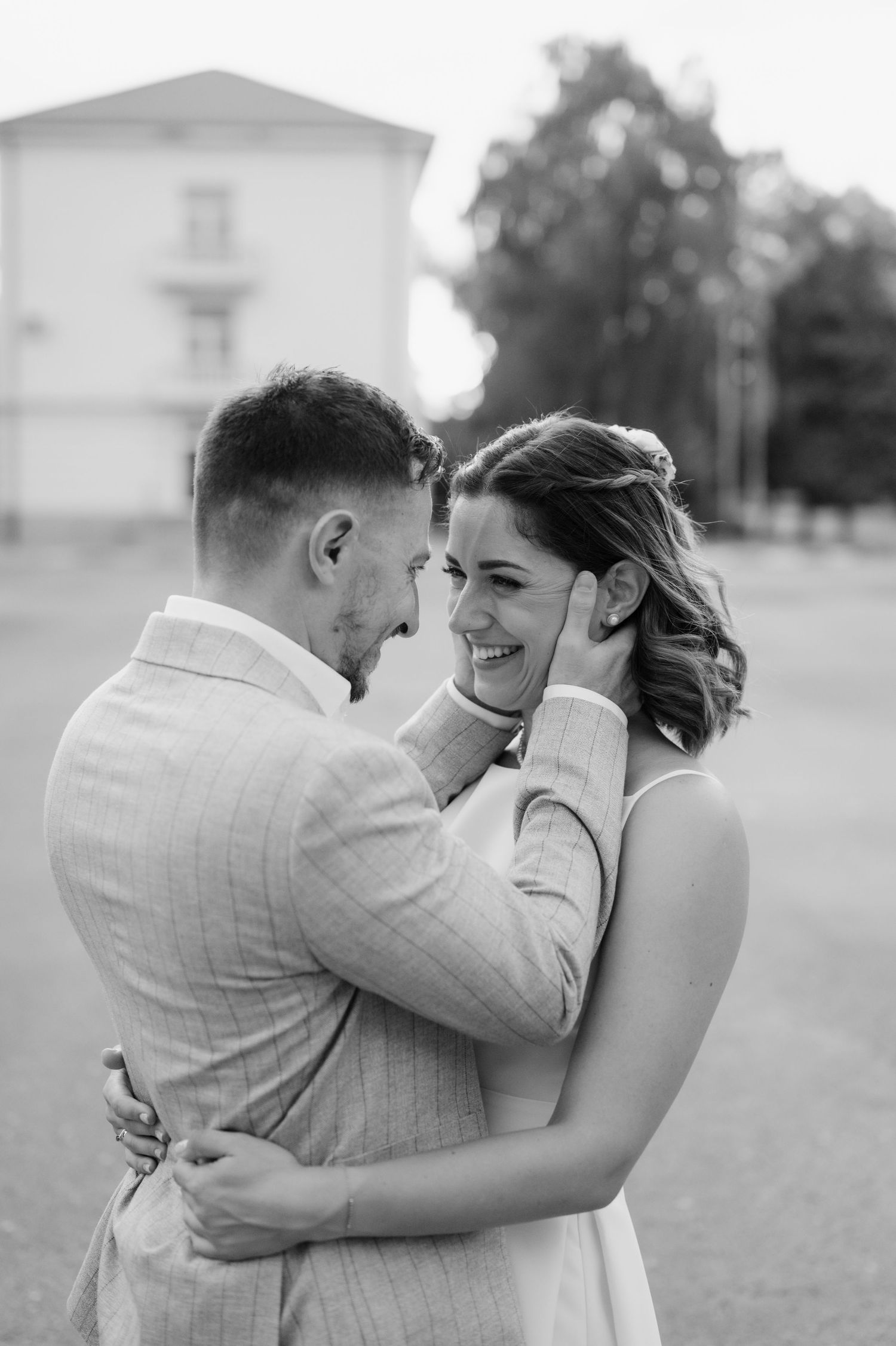 A romantic black and white photo sequence showing a couple embracing and dancing together in an outdoor setting.