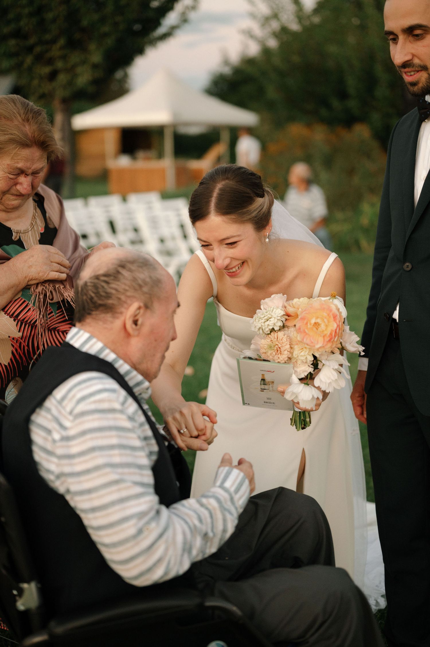 A sequence of four wedding photos shows a sweet moment between guests during an outdoor celebration.