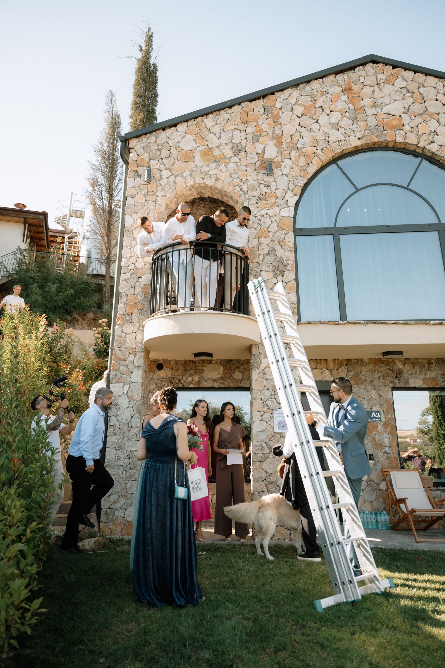 A sequence of photos showing a wedding ceremony in front of a stone building with arched windows at sunset.