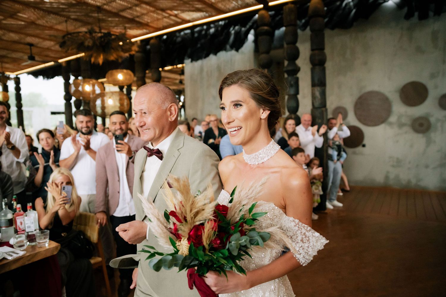 Wedding celebration in a modern industrial space with guests forming lines on either side.