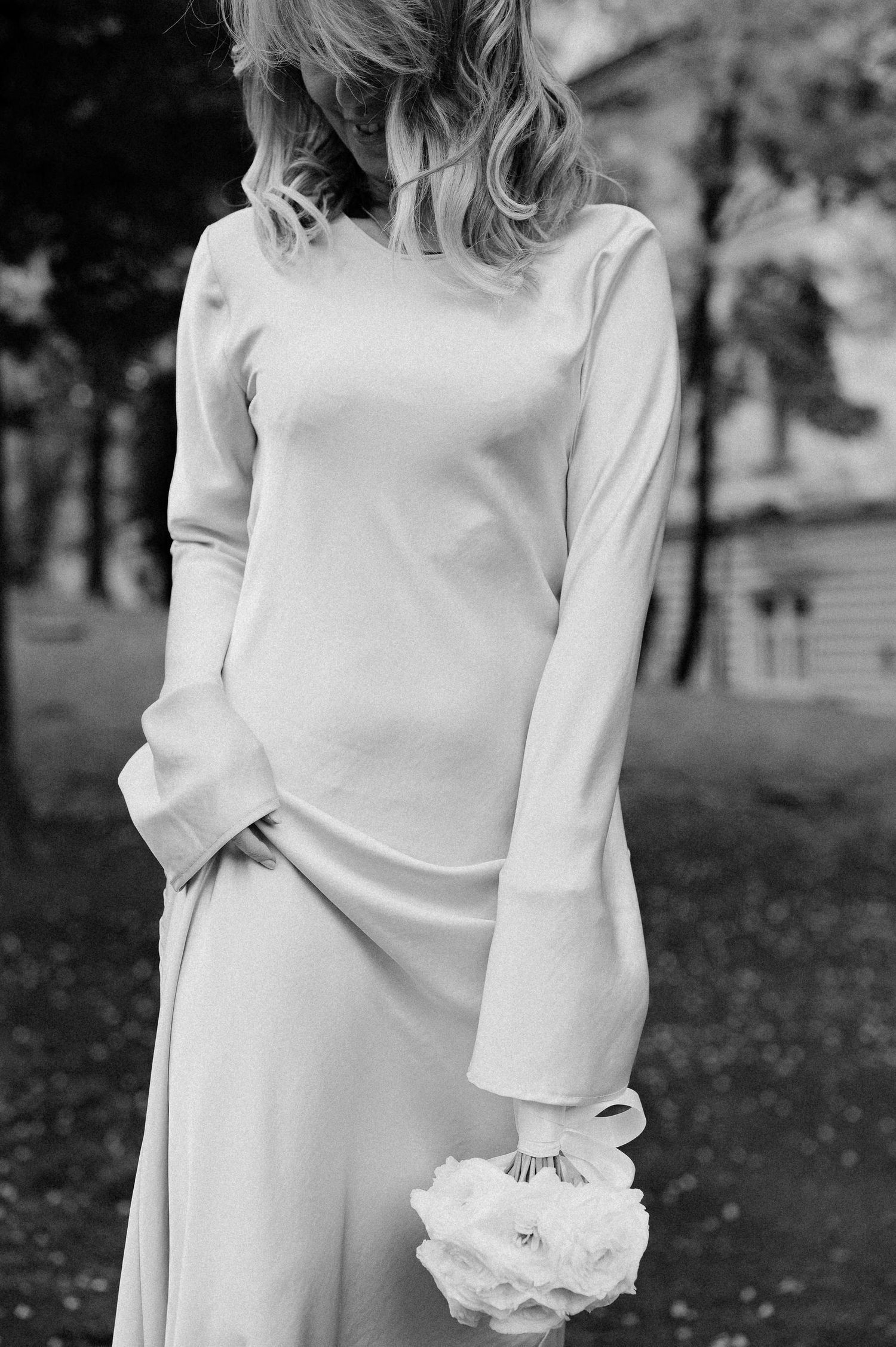 Classic white wedding dress photographed in black and white with delicate floral accents.