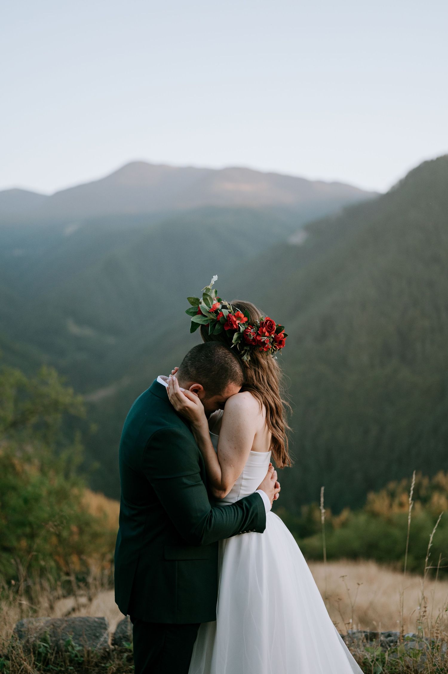 An intimate wedding moment captured against sweeping mountain vistas and natural scenery.
