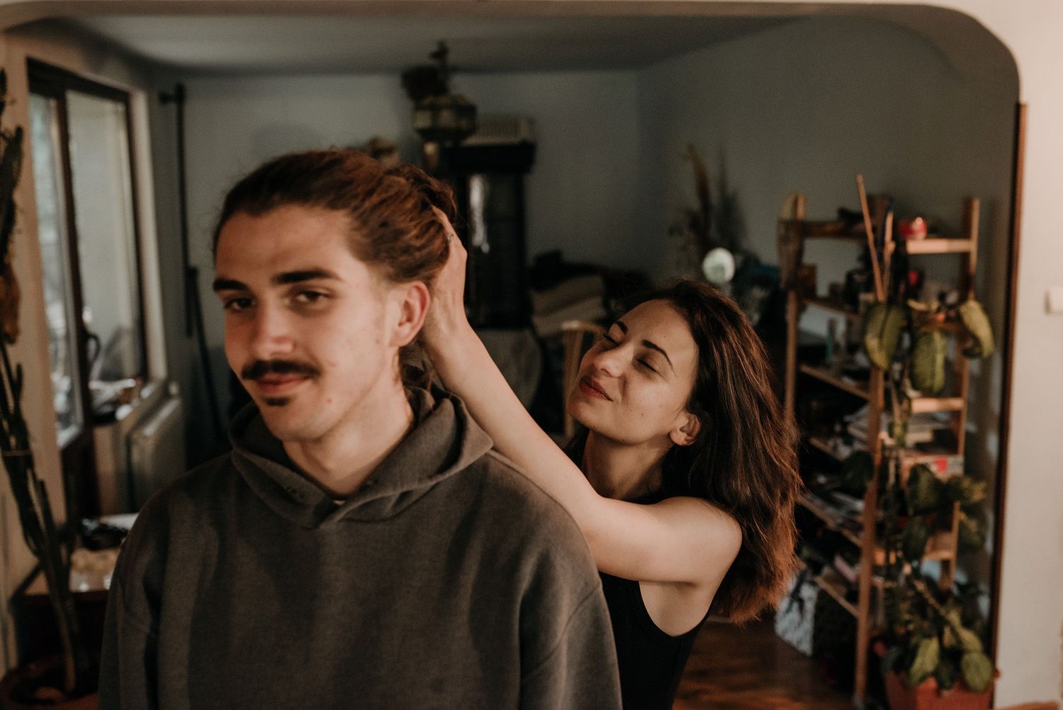 A sequence of romantic indoor portraits capturing playful interactions between partners.