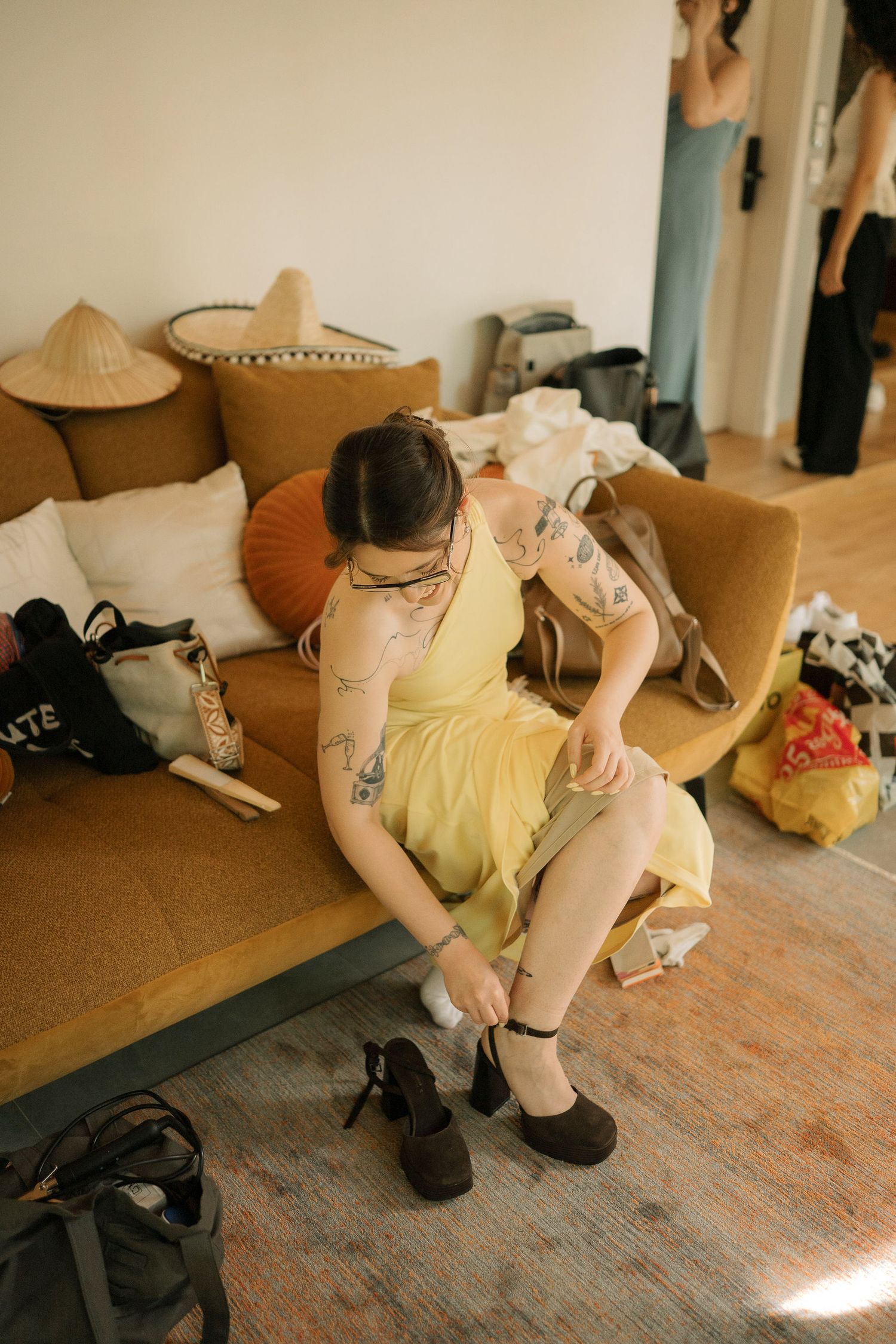 A sequence of images showing someone sitting on a wooden floor in a yellow shirt and black shorts.