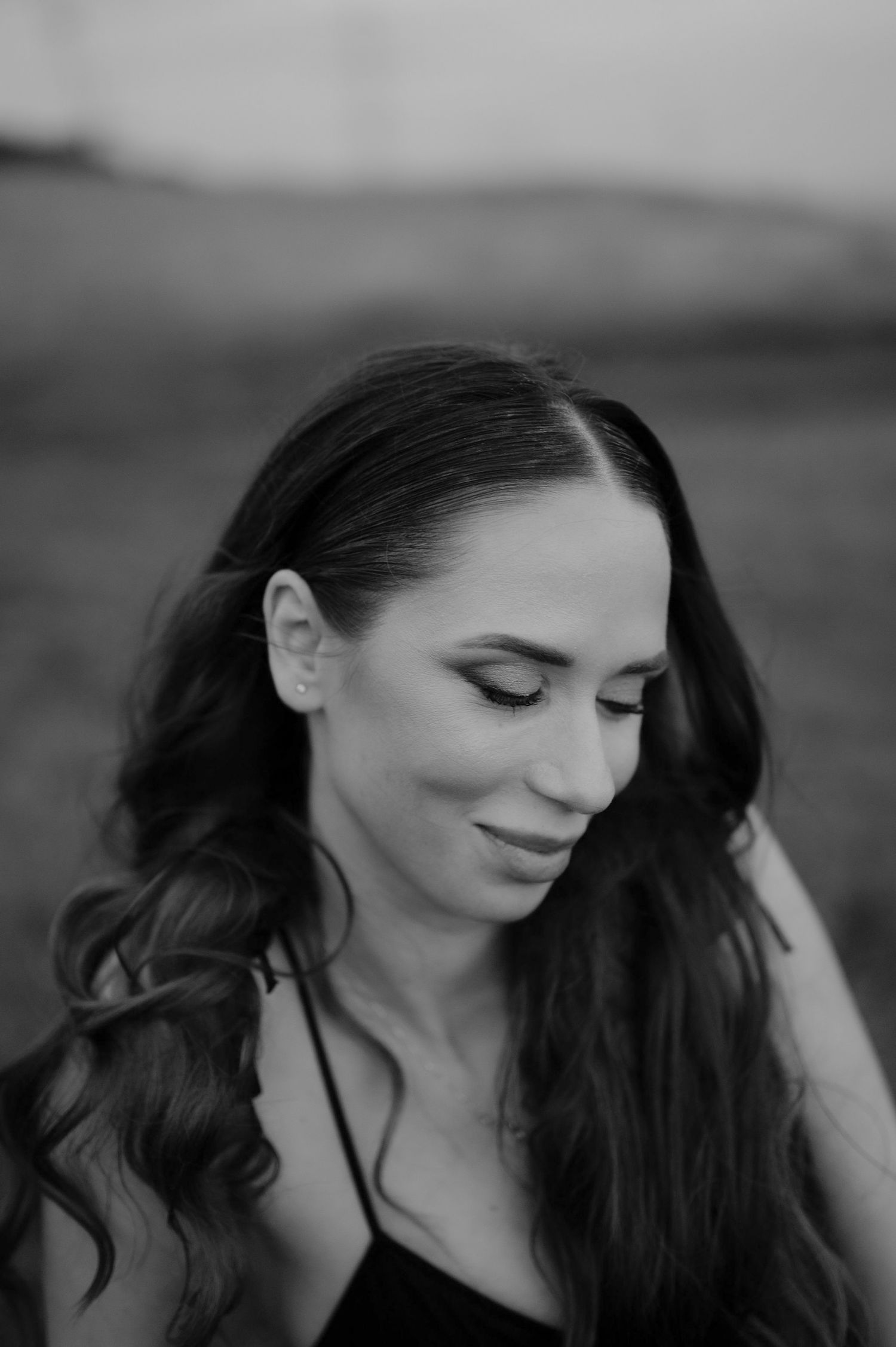 A series of black and white portraits showing a person with dark hair and closed eyes in different poses and expressions.