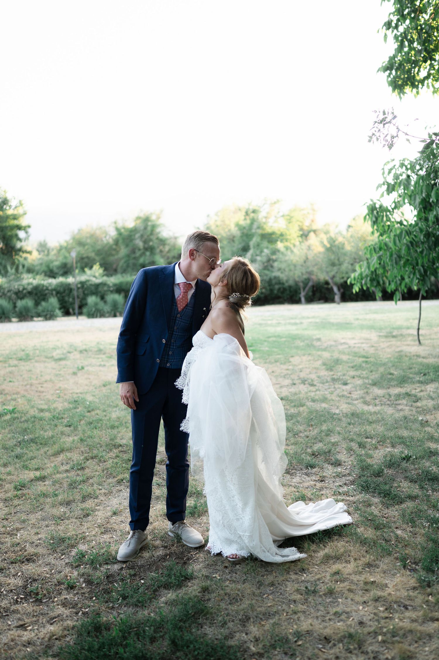 A couple shares a romantic moment in a rustic outdoor setting.