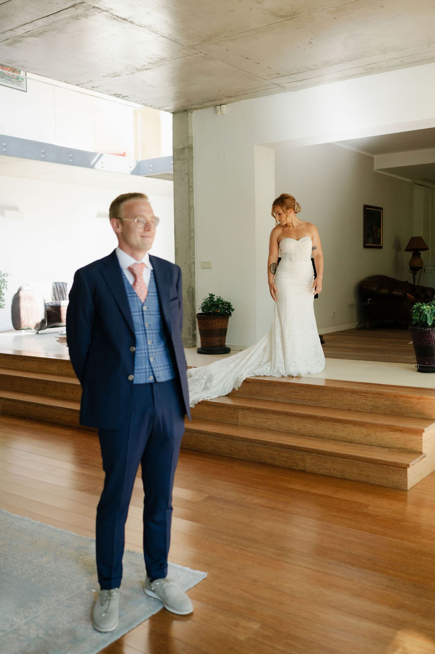 A spacious venue room features hardwood floors and elegant decor for a wedding celebration.