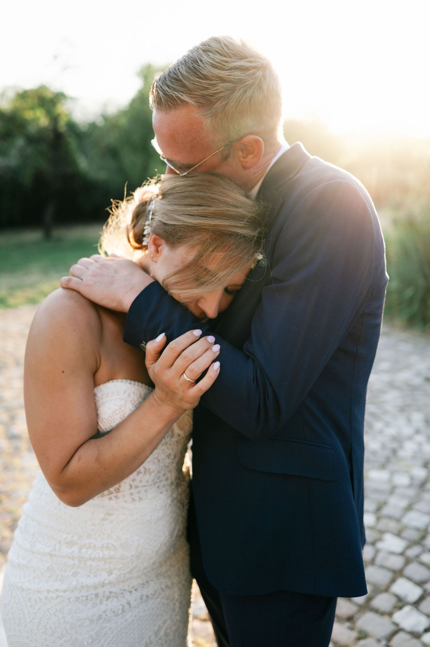 Intimate wedding portraits showing gentle embraces during golden hour.
