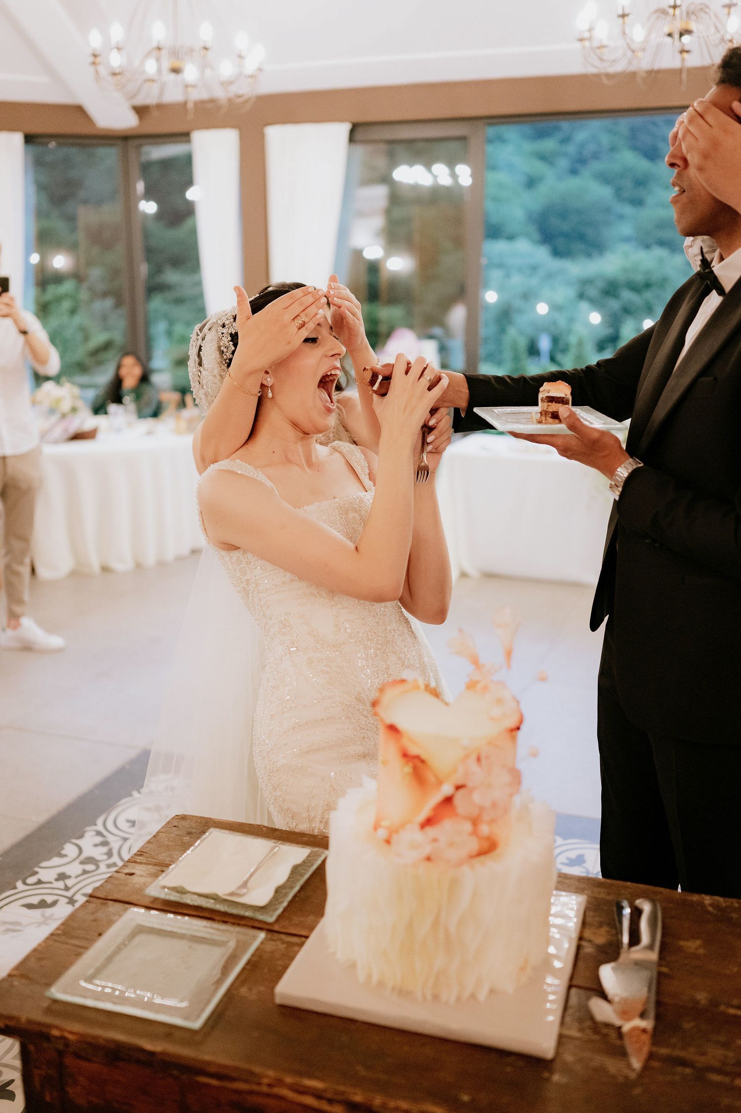A joyful moment during a wedding reception cake tasting game.