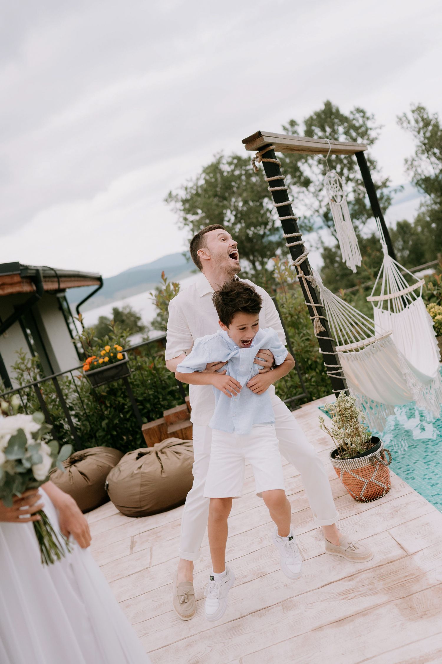 Playful celebration moments on a stone pool deck with macrame decorations.