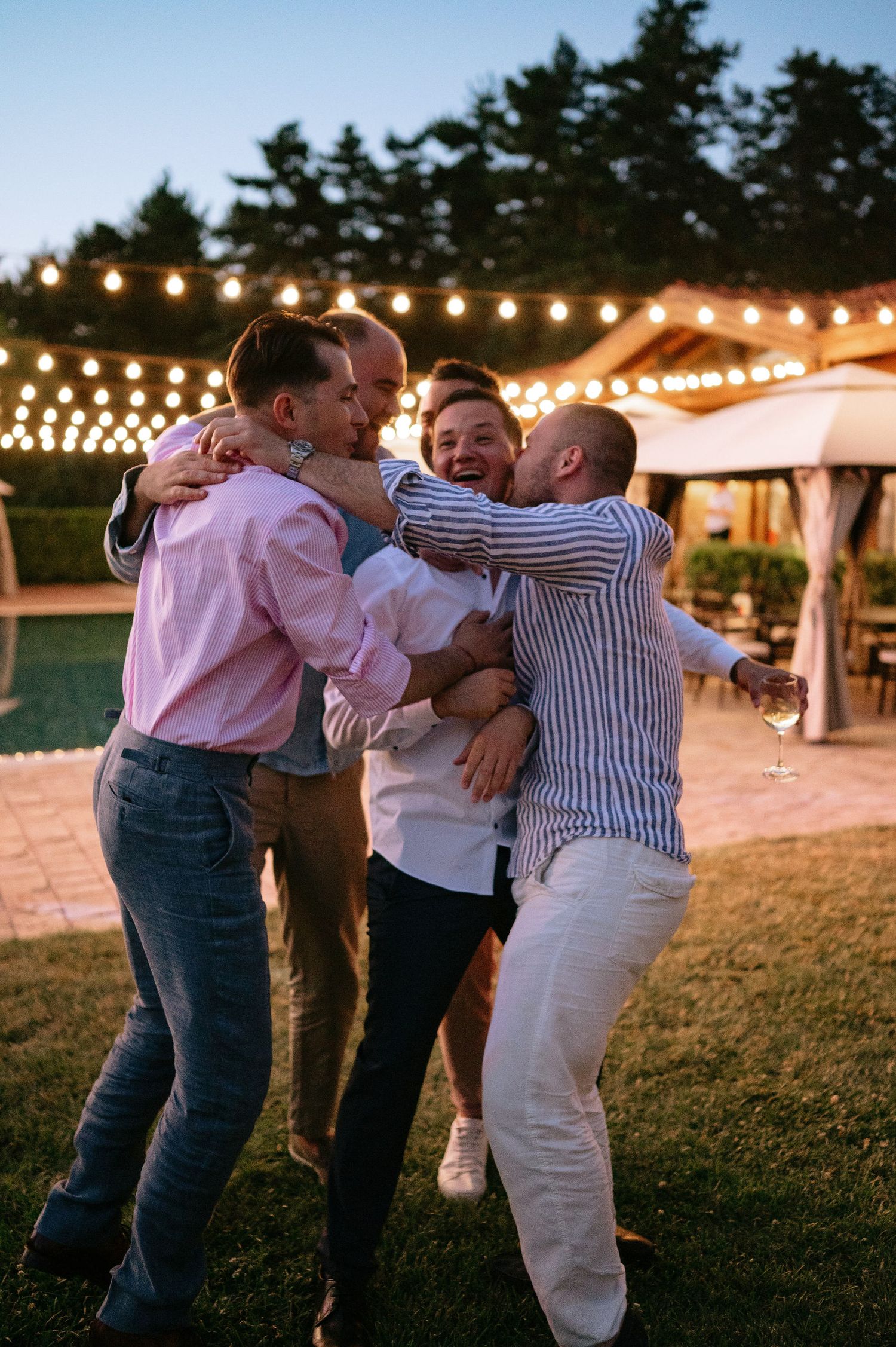 Group of friends sharing an emotional moment during an outdoor celebration.