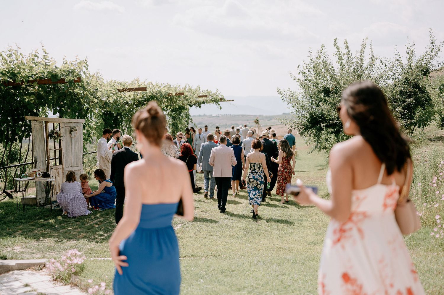 Outdoor wedding ceremony setup with chairs on grassy hillside overlooking scenic views.