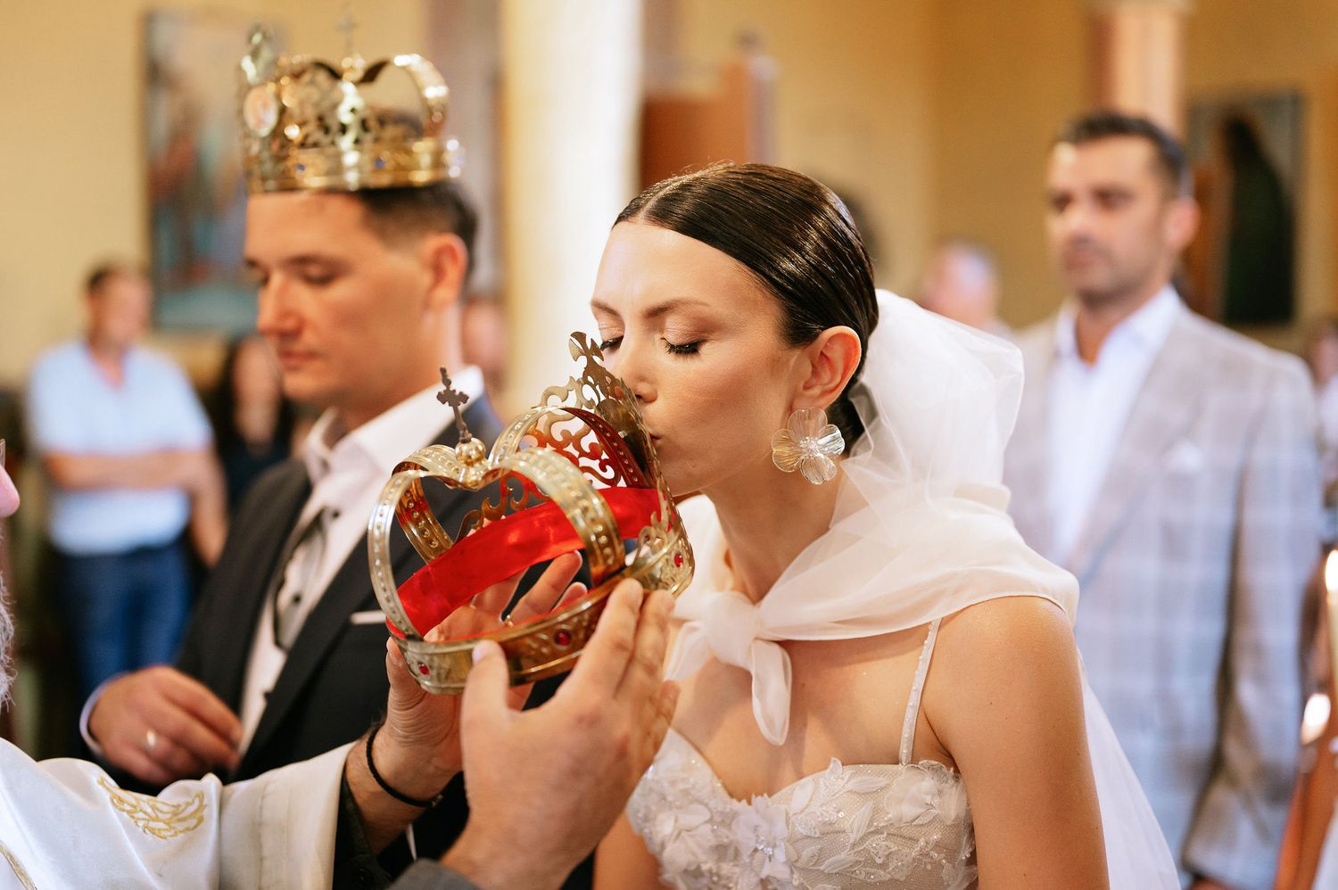 Close-up shots of wedding ceremony participants during a traditional Orthodox church service.