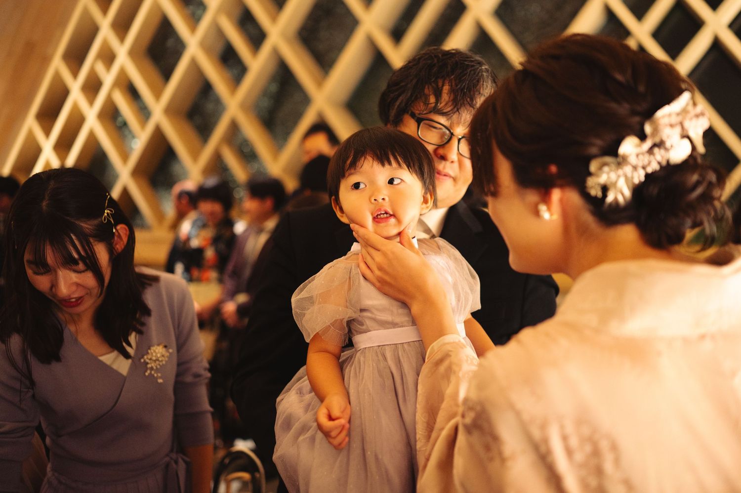 Wedding reception gathering with guests celebrating in modern chapel venue.