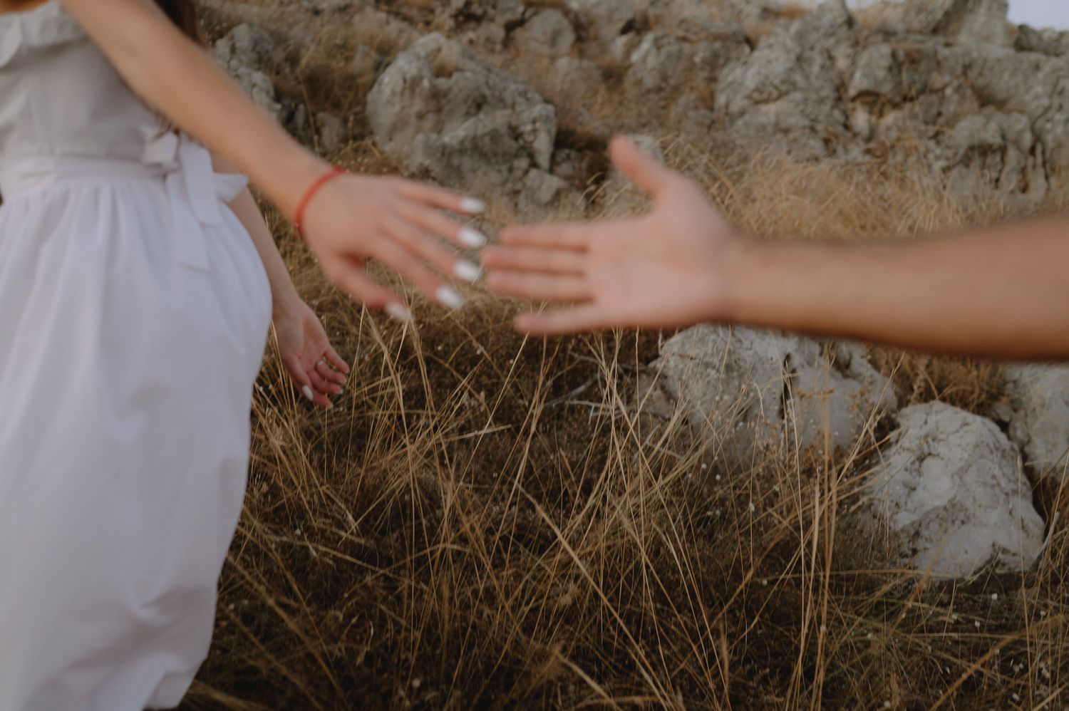 Hands reach out to touch and explore rough textured stone walls in an interactive sensory experience.