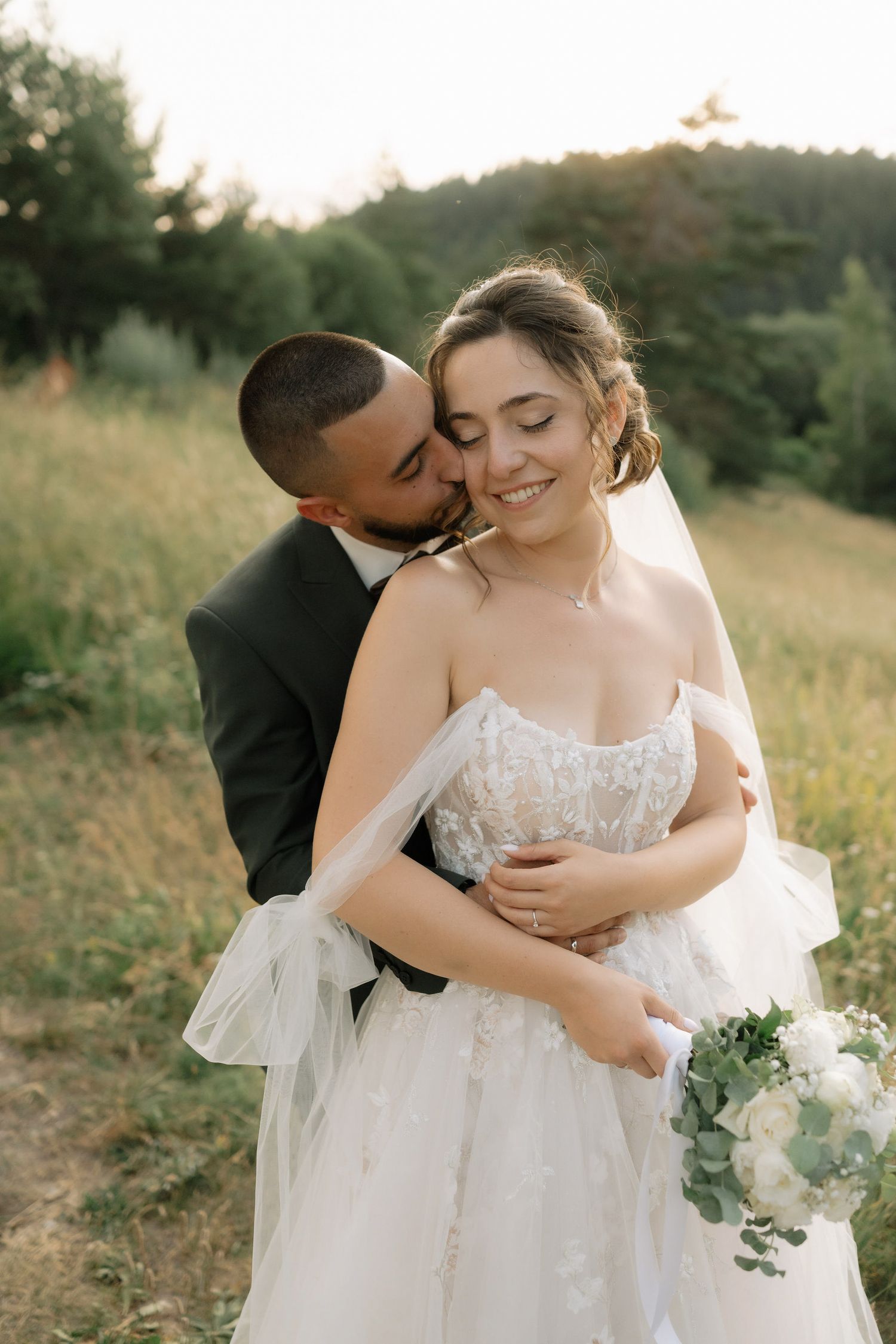 Intimate wedding portraits show tender moments between newlyweds in a natural outdoor setting.