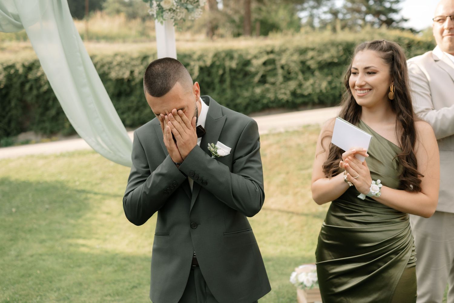 A series of emotional reactions during a first look wedding moment in an outdoor garden setting.