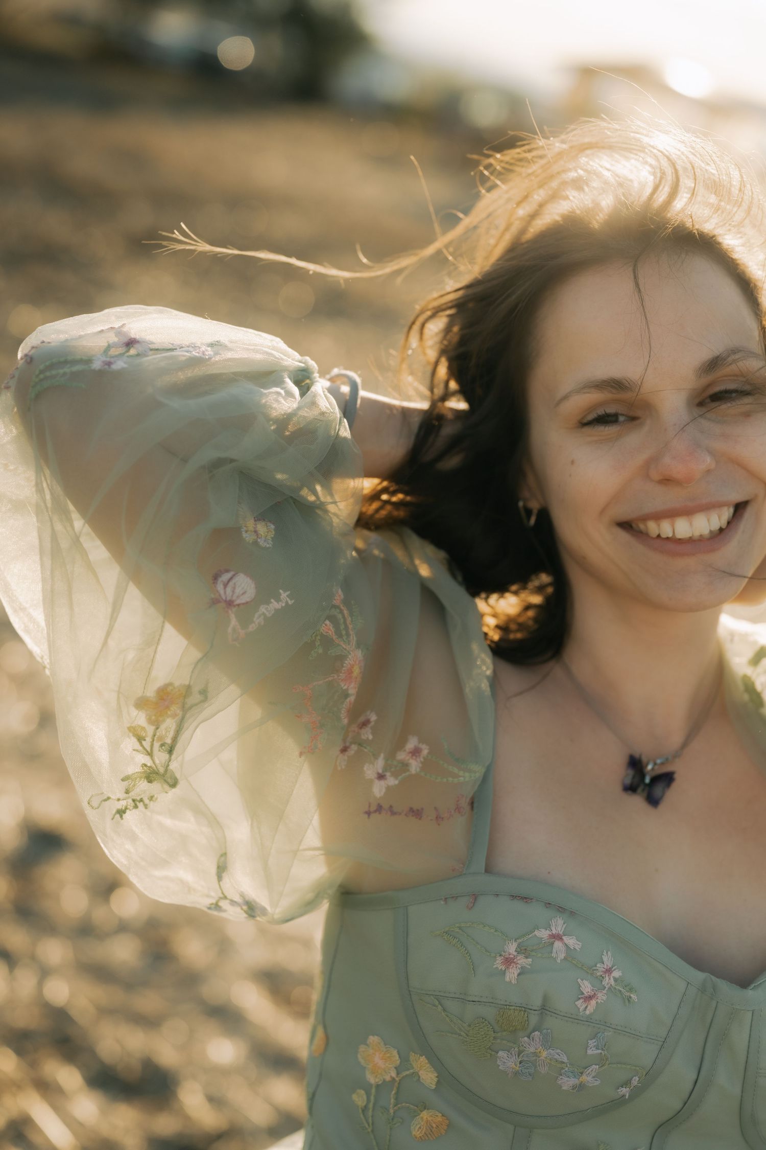 A dreamy sequence of portraits showing someone in a mint green dress with floral details at golden hour.