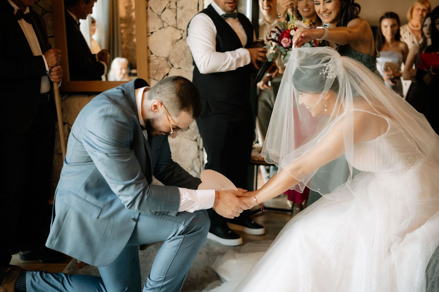 A joyous wedding reception dance sequence showing guests celebrating on a rustic wooden dance floor.