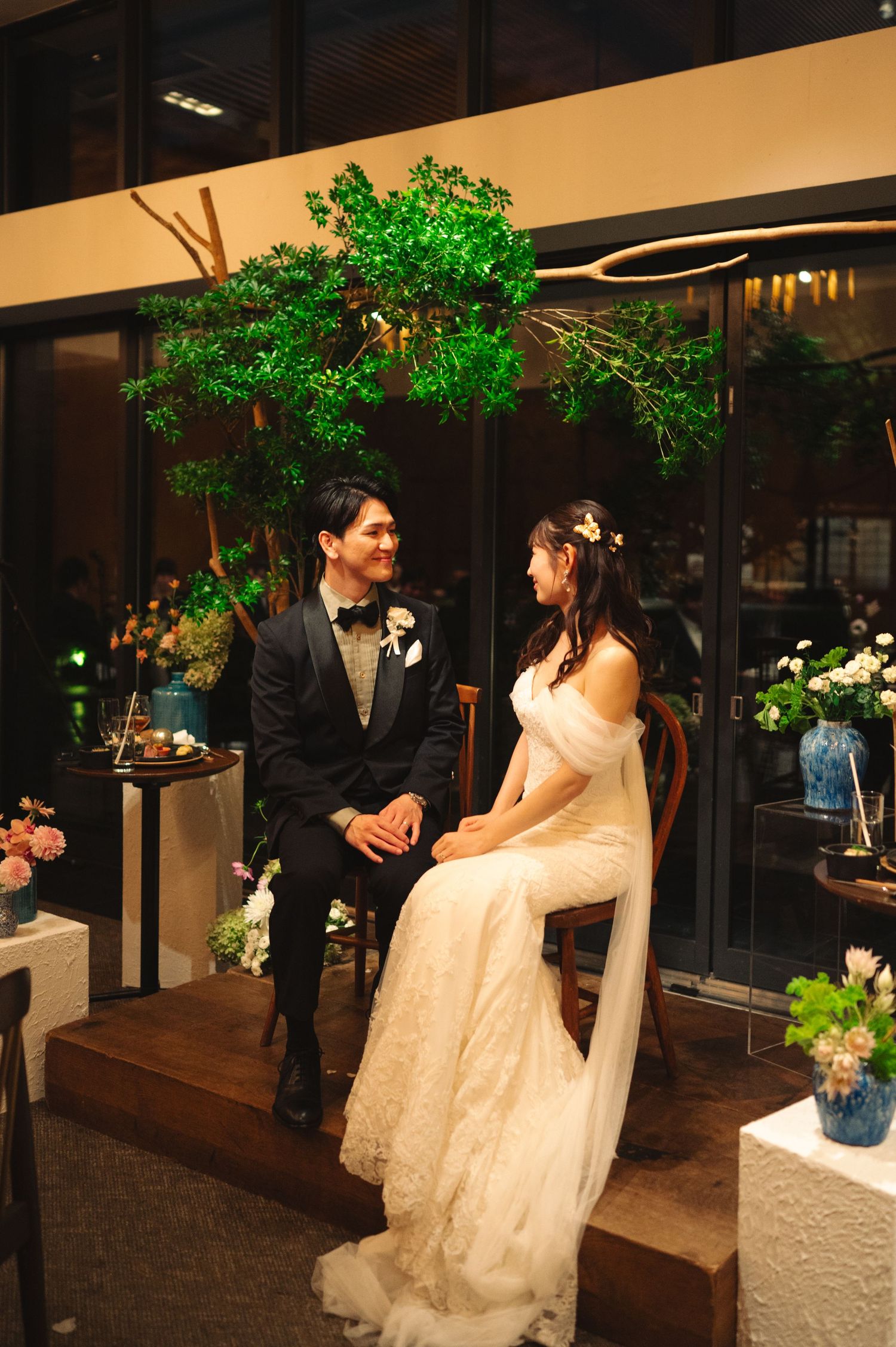A couple poses under decorative green lighting at their wedding reception venue.