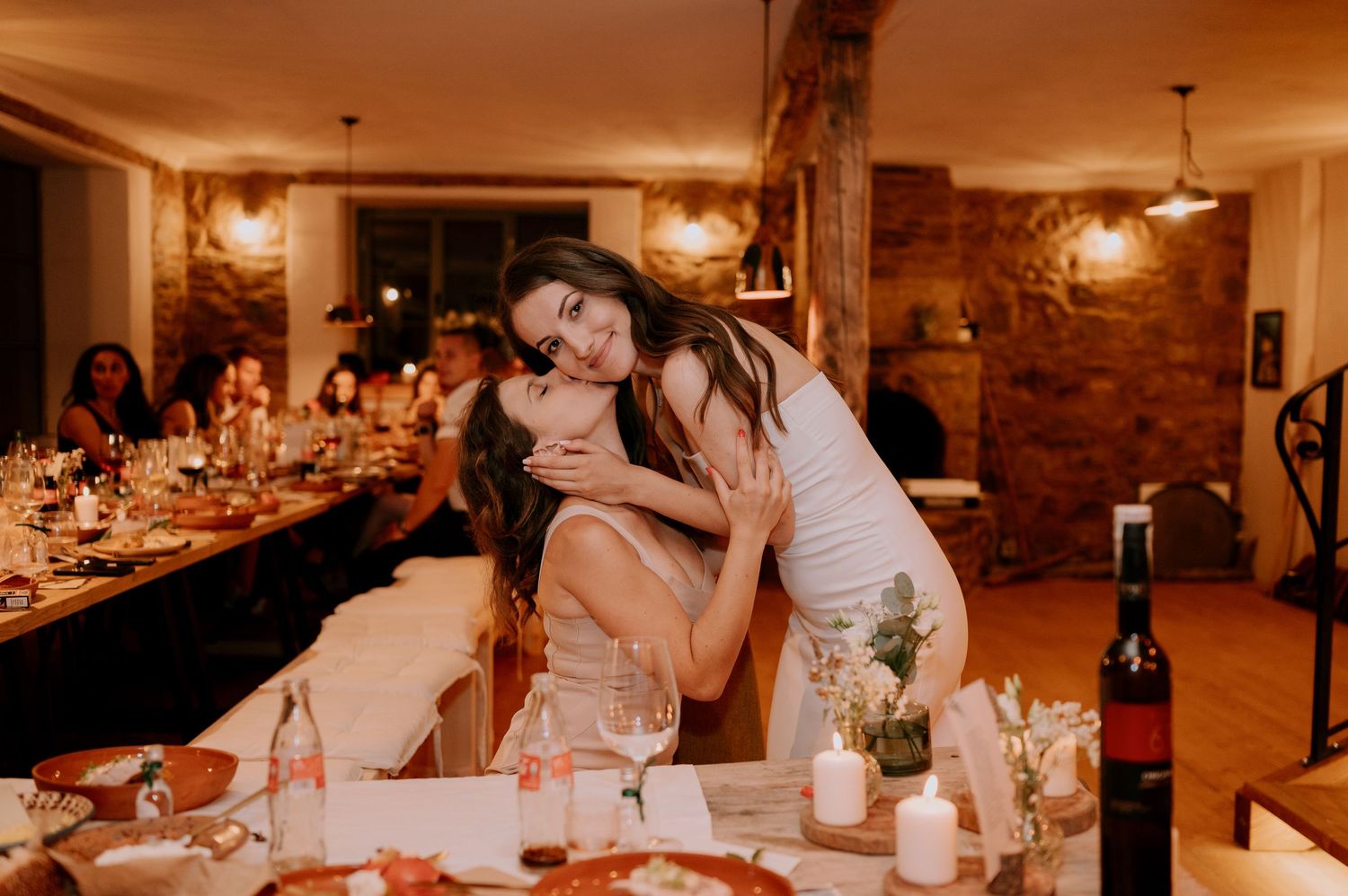 Candid moments from a wedding reception showing guests dining and laughing in warm ambient lighting.