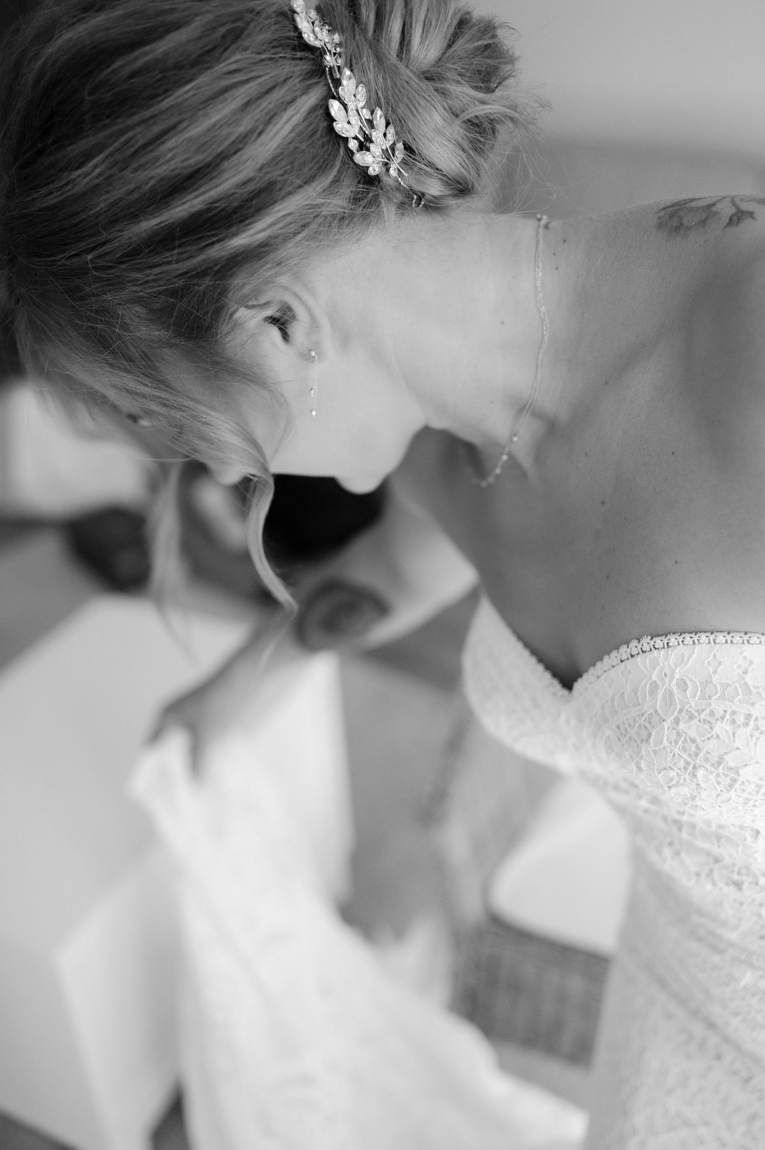 Intimate black and white portrait showing delicate lace details and crystal hair accessory.