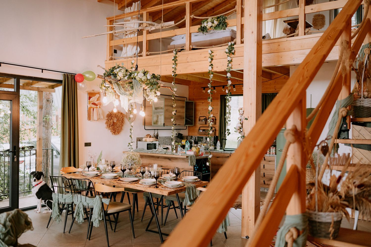 Modern rustic dining room with wooden beams and elegant table settings.