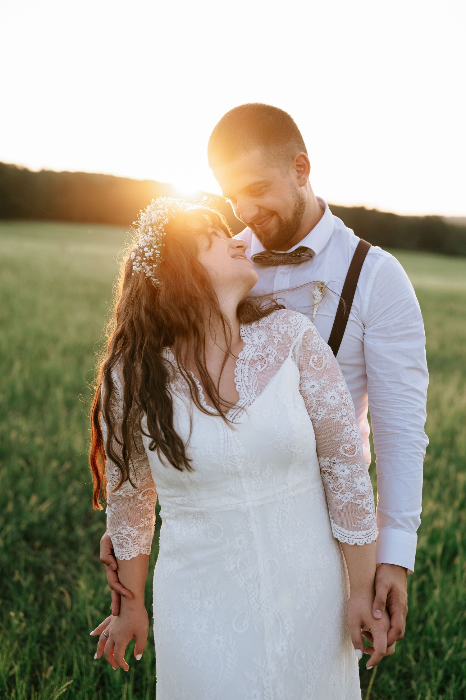 Intimate moment between newlyweds during golden hour photography session.