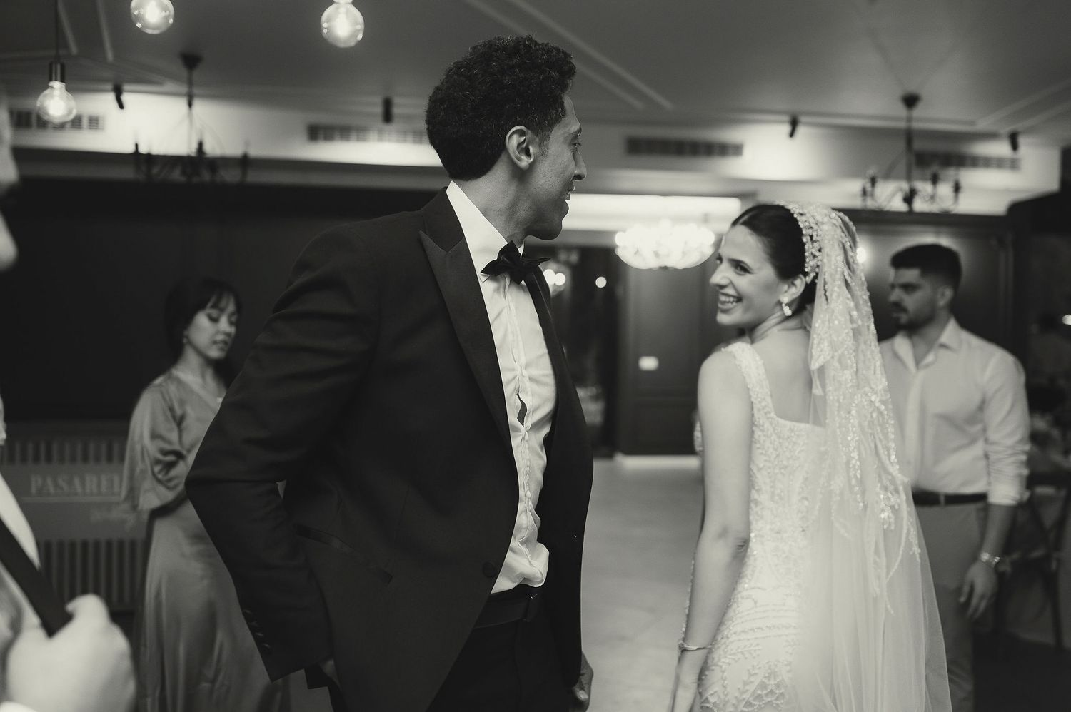 A black and white vintage wedding photo capturing a romantic moment on the dance floor.