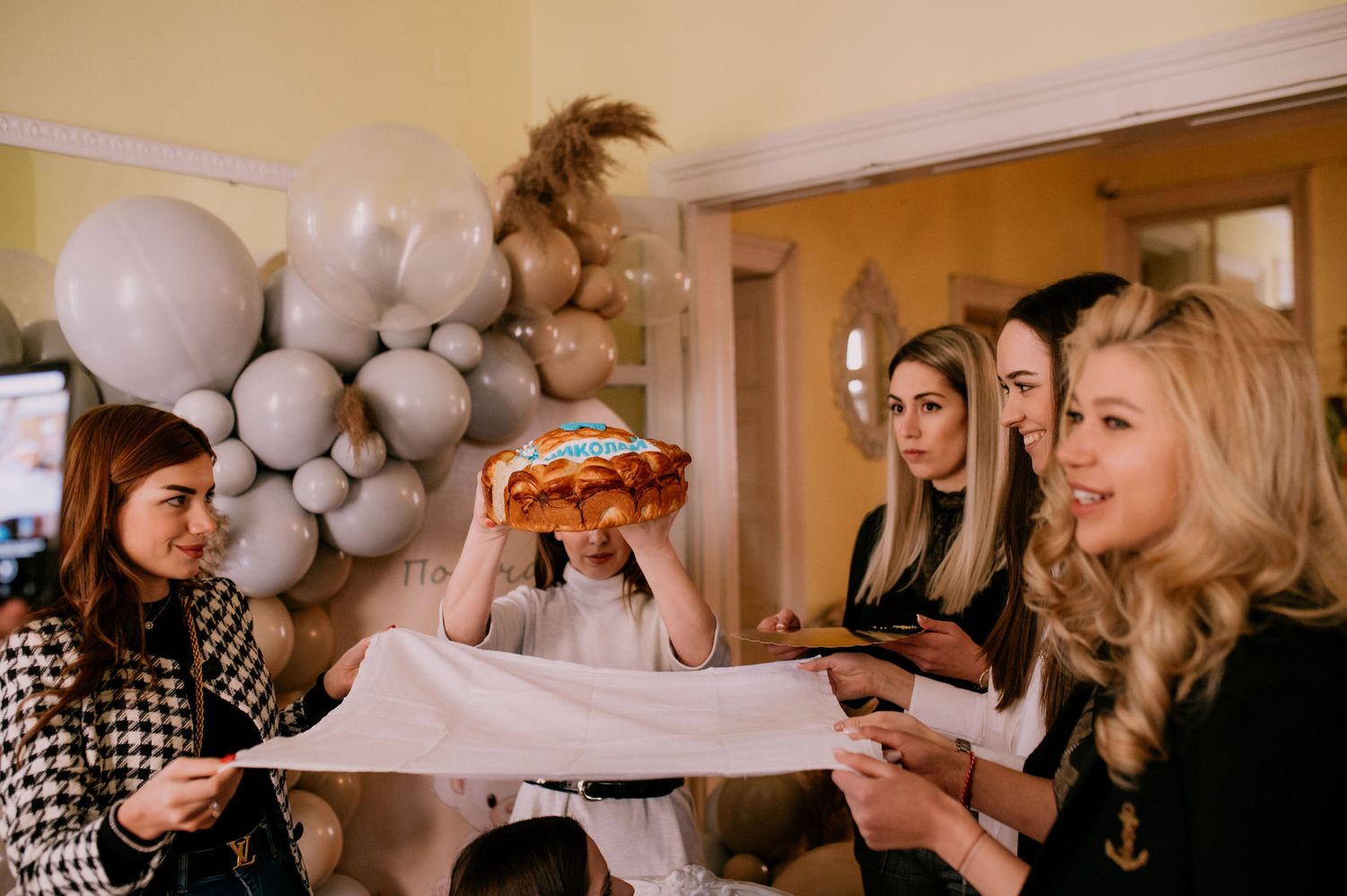 A series of party photos showing people celebrating with balloons and drinks in an indoor setting.