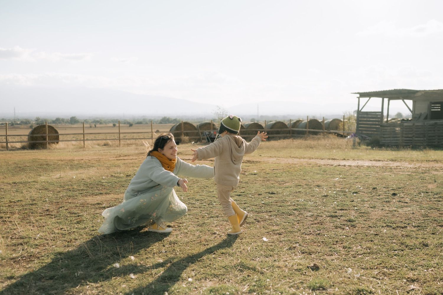 A sequence of action shots showing a person doing a parkour flip on dry grass terrain.