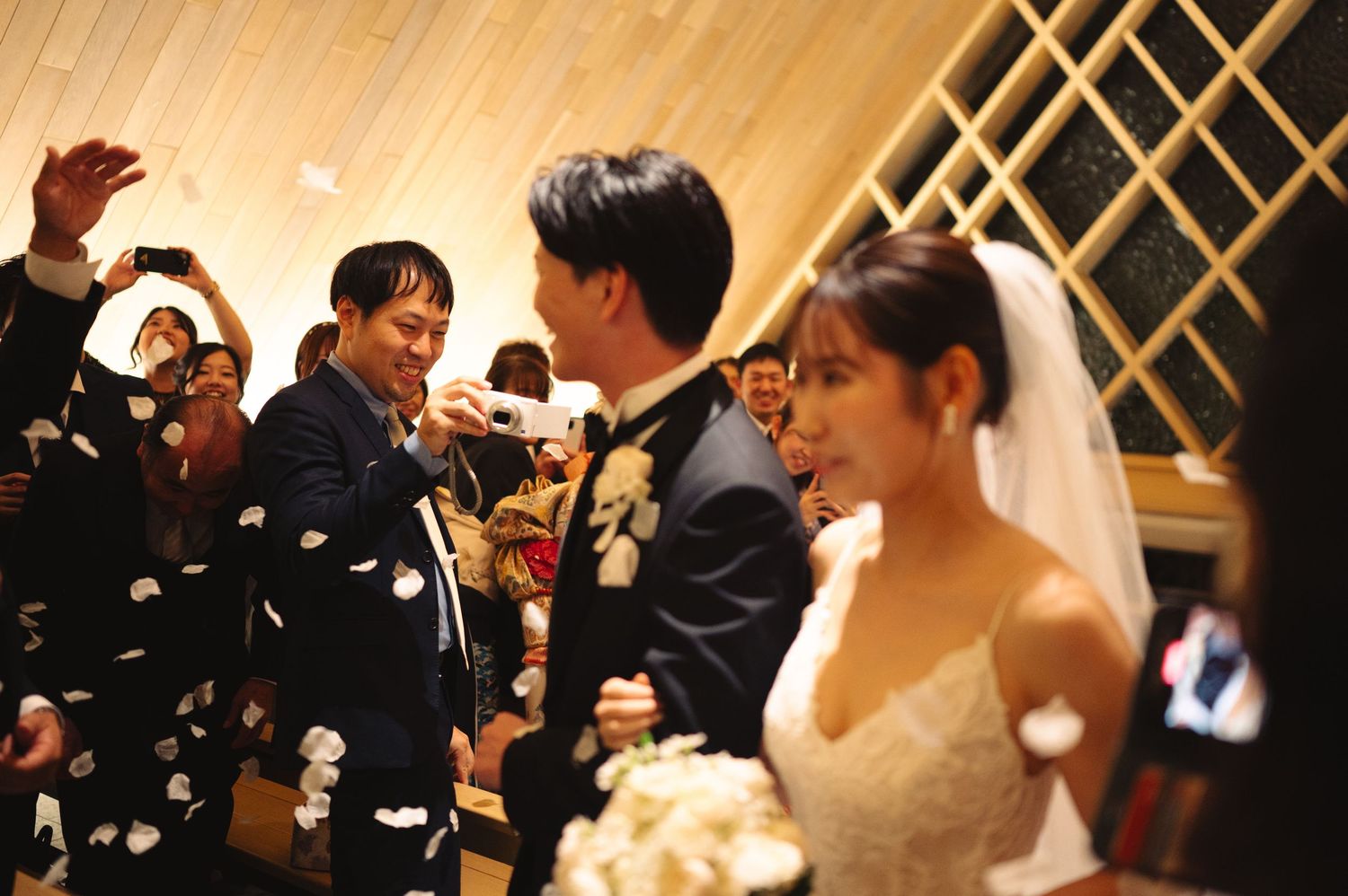 Wedding celebration with confetti and joyful moments in a modern chapel setting.