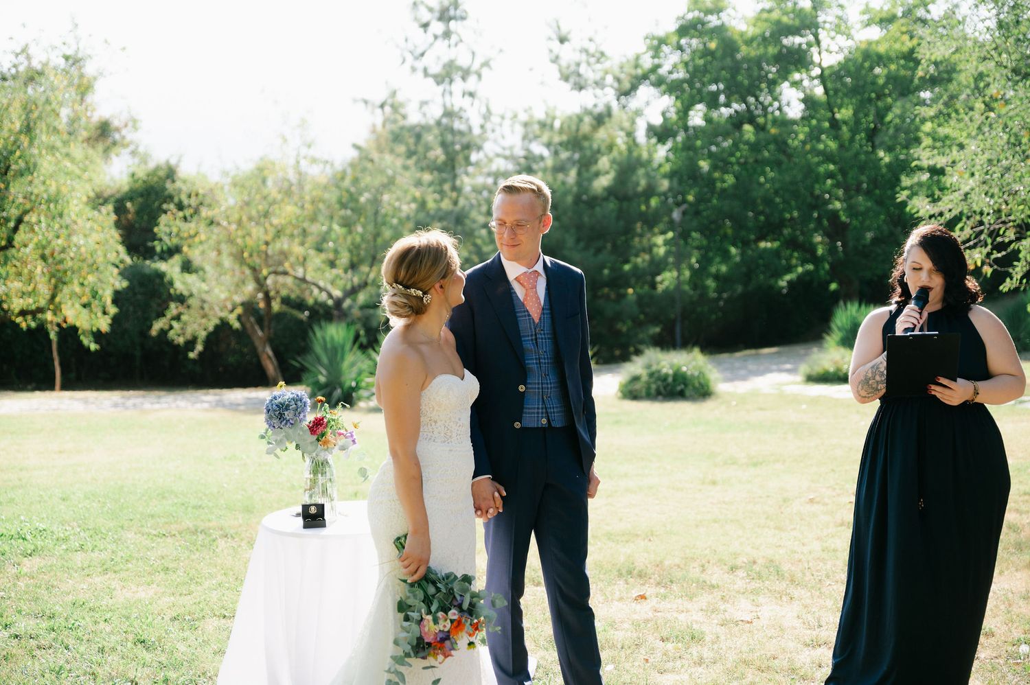 Wedding party poses in a scenic outdoor setting with natural lighting.