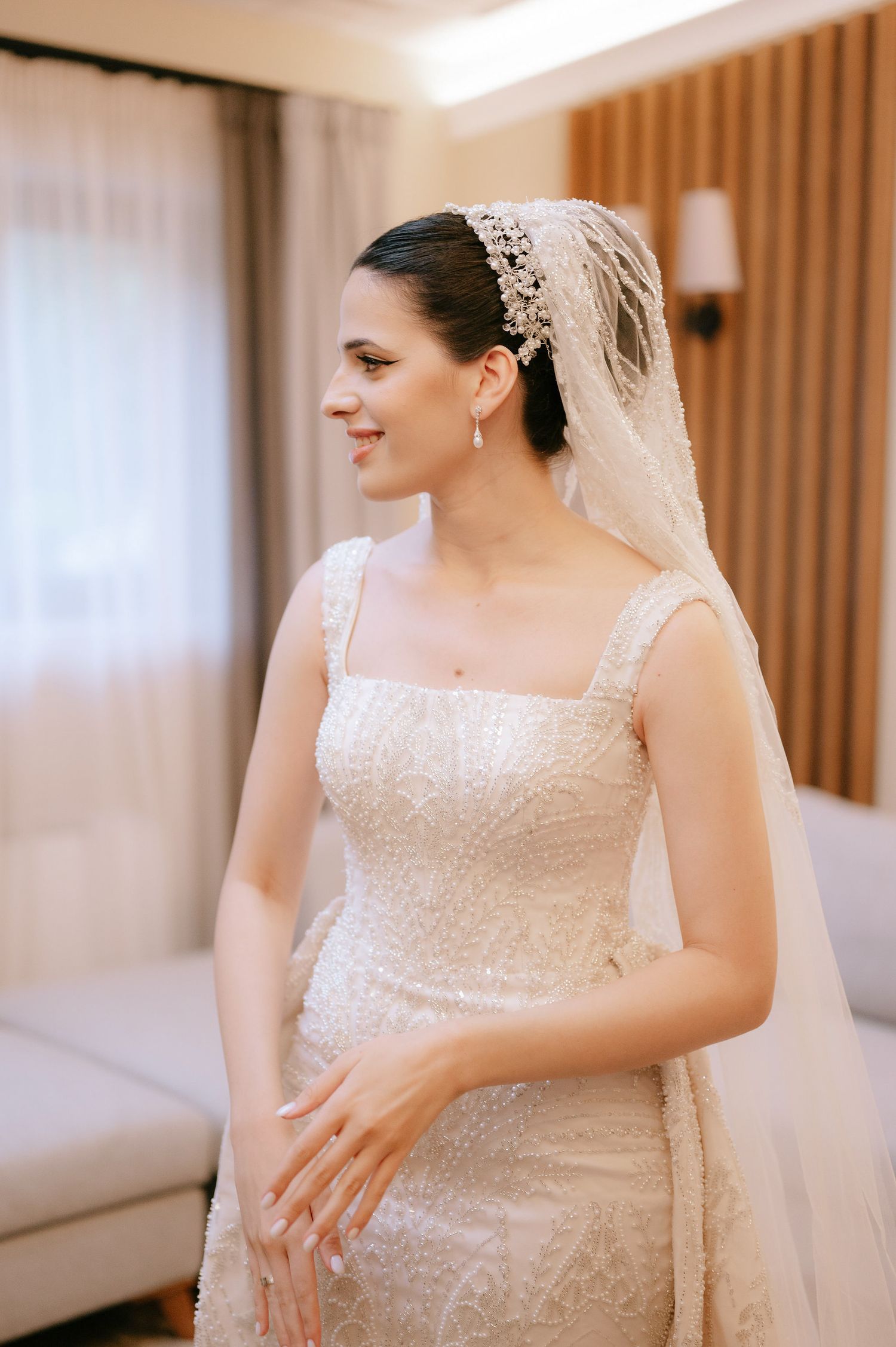 Close-up shots of a beautiful sequined wedding dress with delicate veil details.