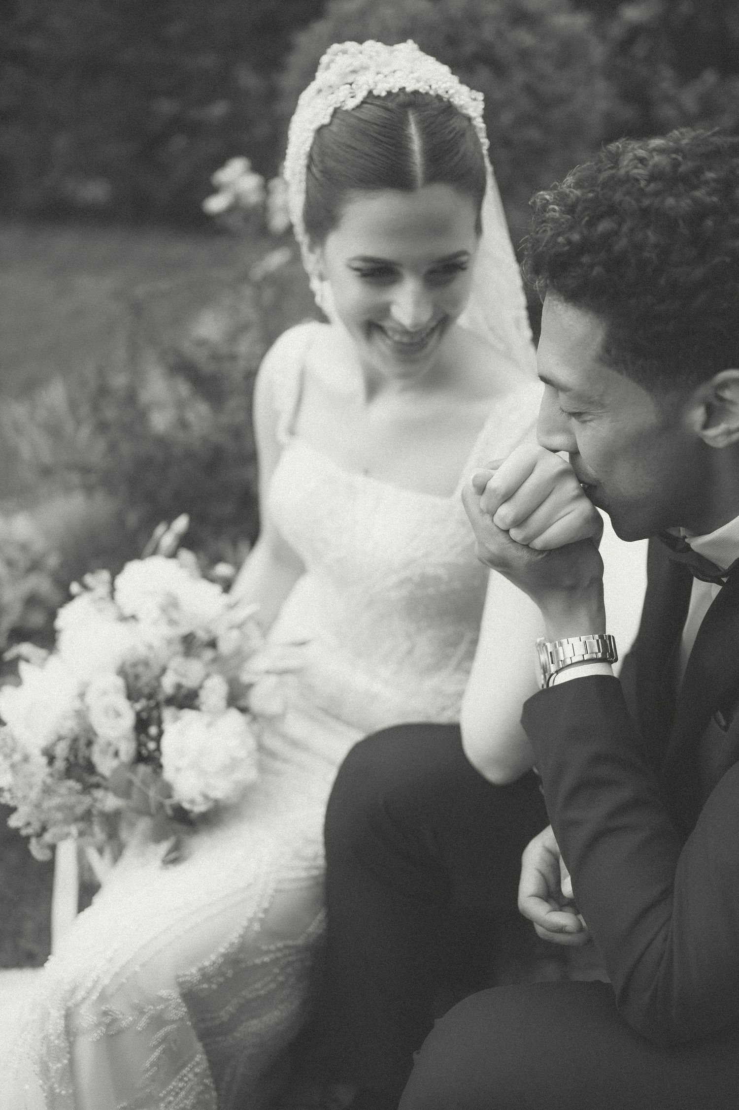 Black and white romantic wedding portrait showing tender moments between the couple.