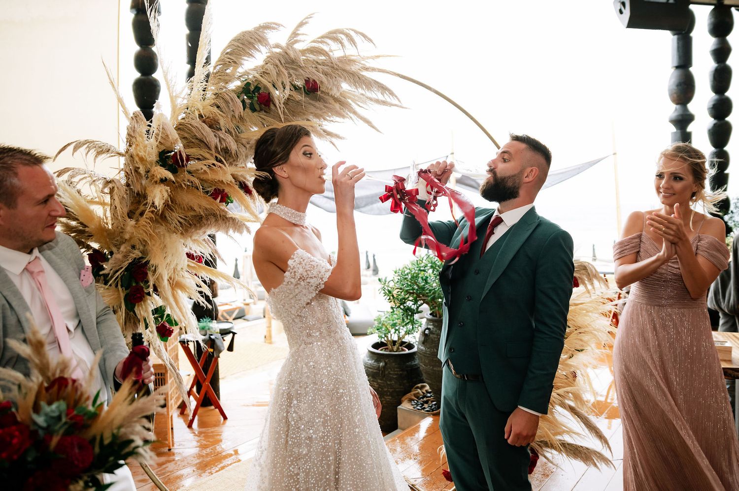 Wedding celebration unfolds in a rustic indoor space with warm lighting and natural decor elements.